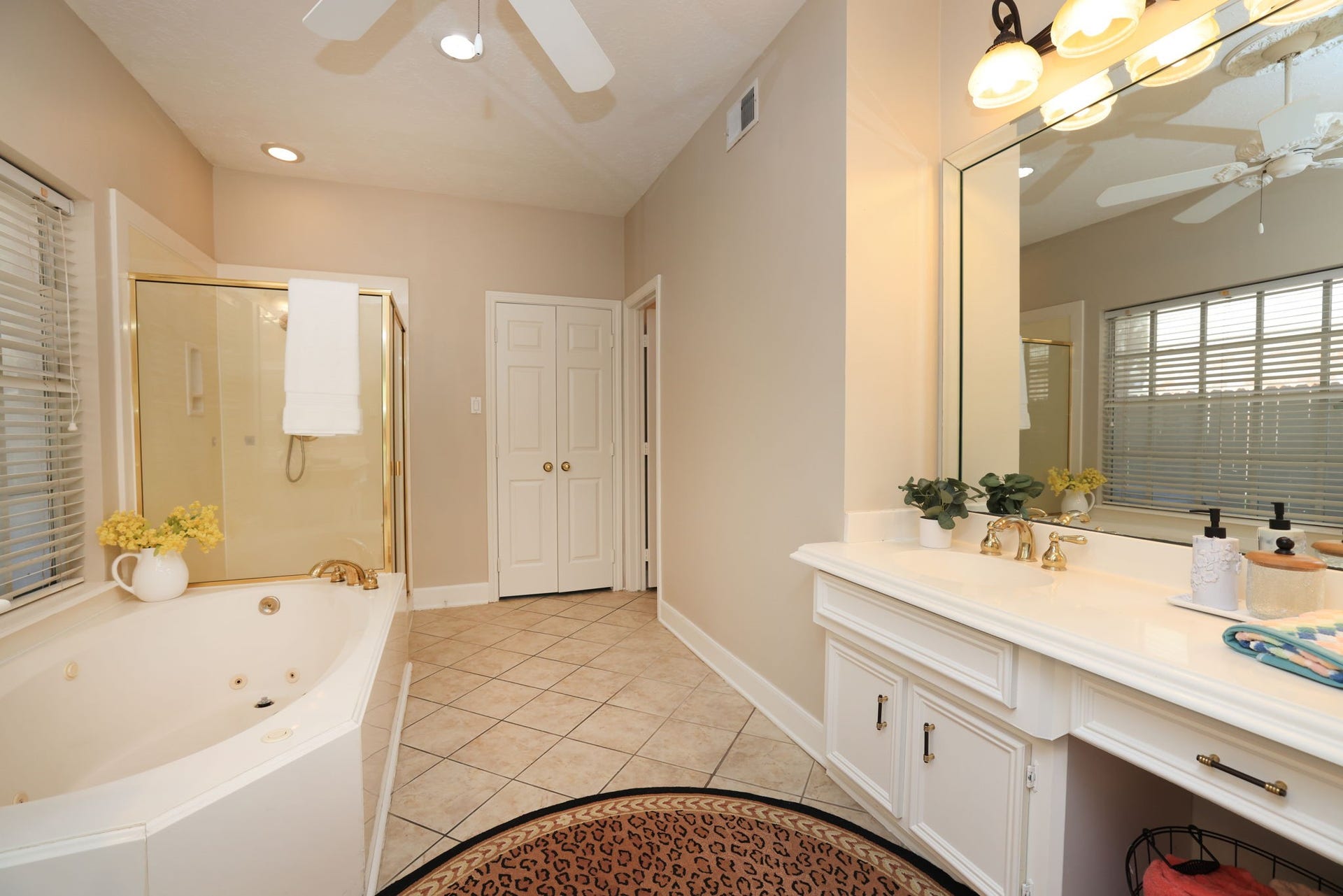 16107 Abberton Hill Drive, Spring, TX 77379 Primary bath features a jetted soaking tub, separate shower, and dual vanities with gold-tone fixtures.