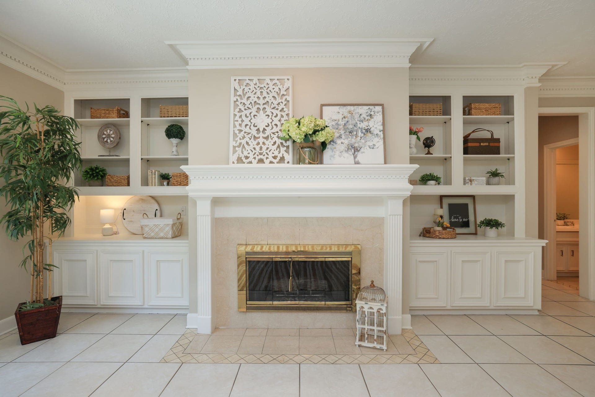 16107 Abberton Hill Drive, Spring, TX 77379 Elegant marble fireplace surrounded by custom built-insan impressive focal point in the family room.