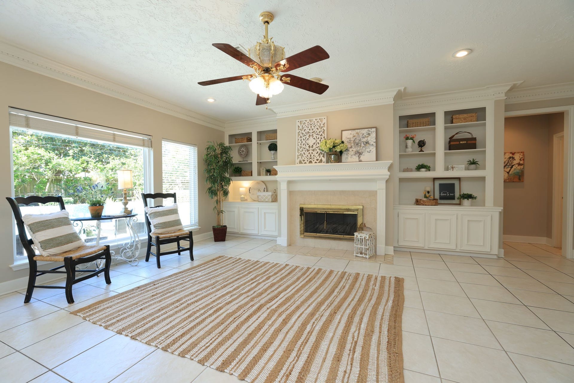 16107 Abberton Hill Drive, Spring, TX 77379 Wall of windows fills the space with natural light, showcasing the detailed millwork and open built-in shelving.