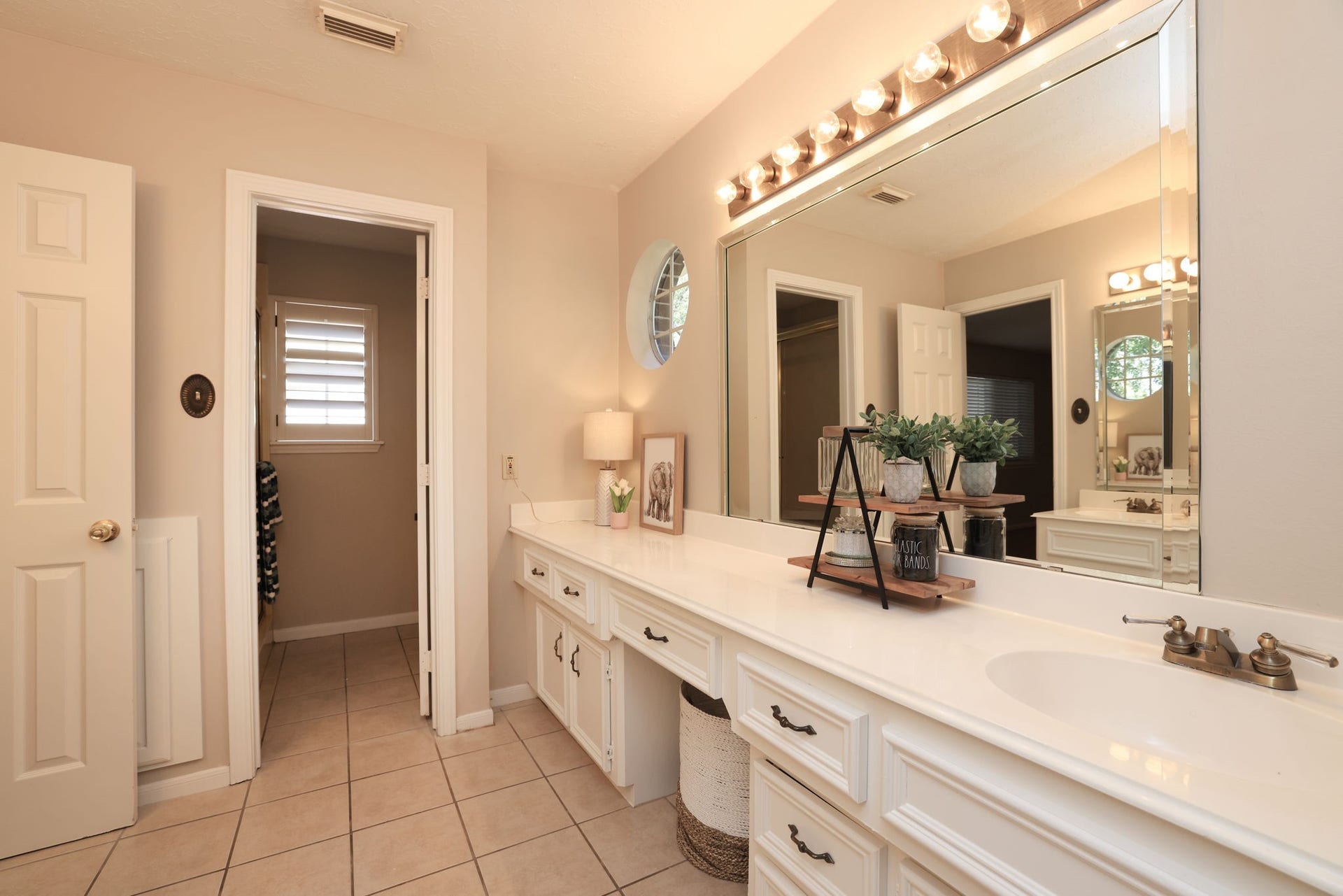 16107 Abberton Hill Drive, Spring, TX 77379 Full upstairs bath with extended dual vanities, updated lighting, and neutral finishes.