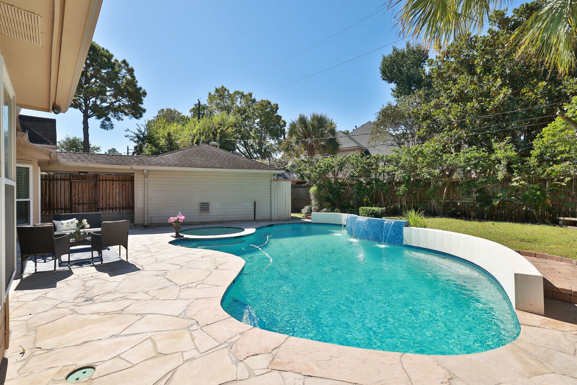 16107 Abberton Hill Drive, Spring, TX 77379 Expansive stone patio provides ample seating and entertaining space beside the pool.