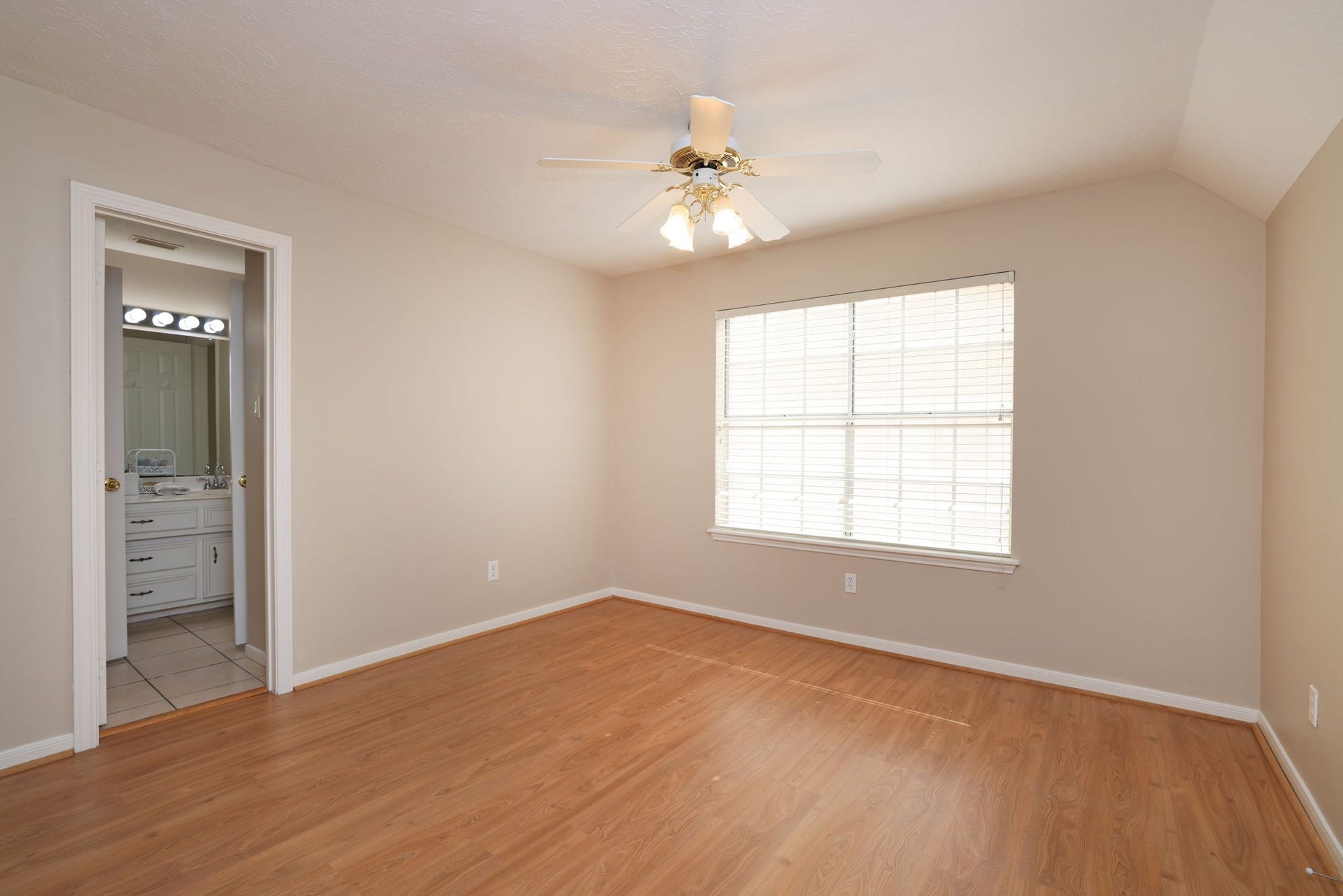16107 Abberton Hill Drive, Spring, TX 77379 Generously sized secondary bedroom with large window, ceiling fan, and walk-in closet.