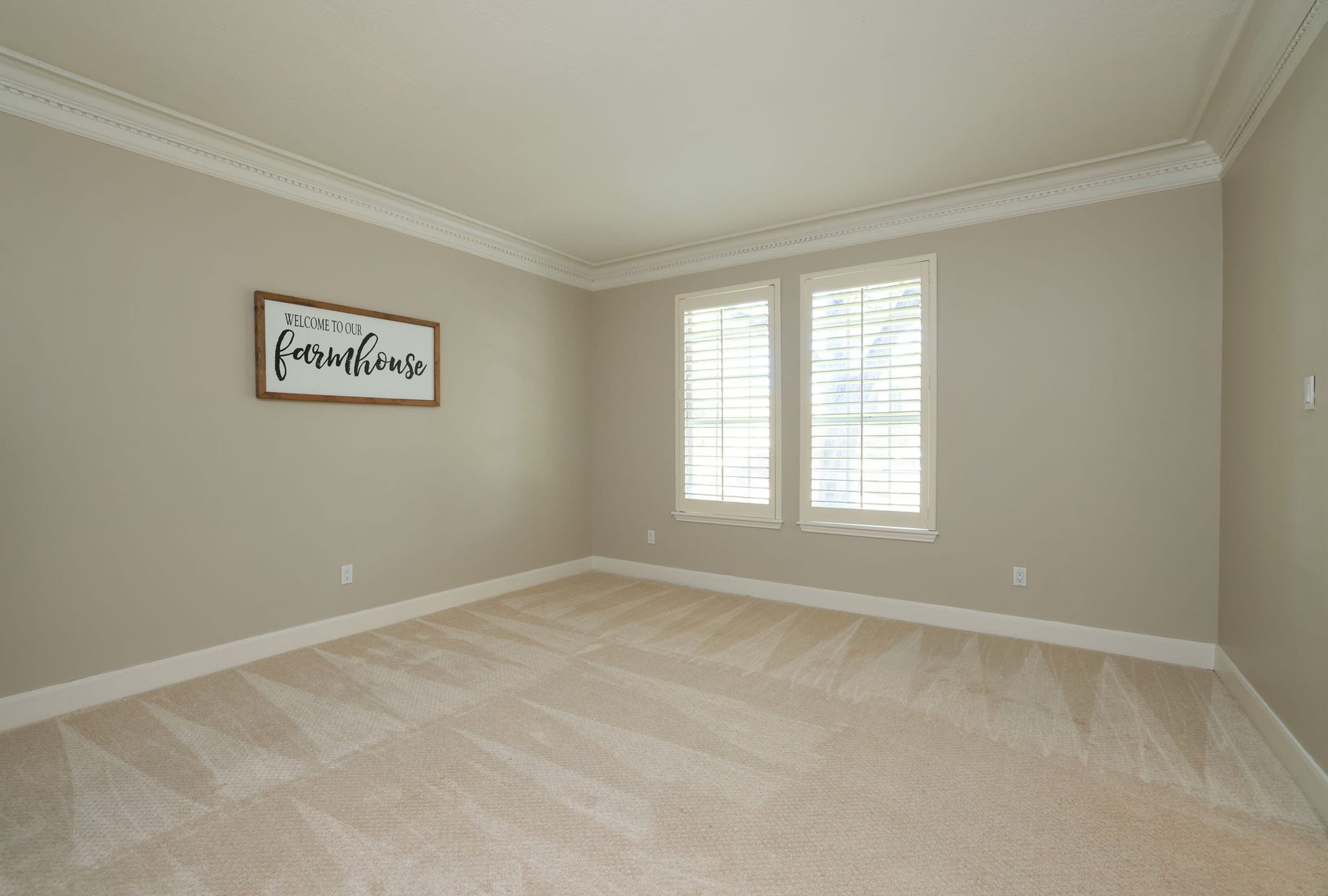 16107 Abberton Hill Drive, Spring, TX 77379 Flexible formal living room ideal for formal living or home office with crown molding, neutral palette, and plantation shutters.