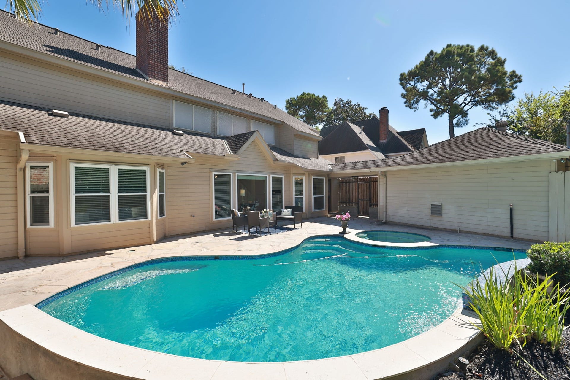 16107 Abberton Hill Drive, Spring, TX 77379 Sparkling pool and spa with a wide flagstone deck, perfect for outdoor dining, relaxing, or entertaining in your private backyard retreat.