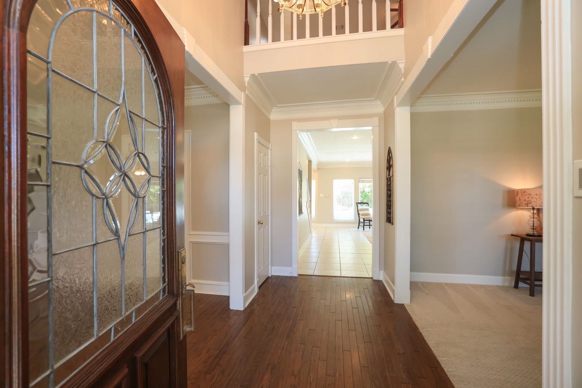 16107 Abberton Hill Drive, Spring, TX 77379 Grand entry opens to the living and dining areas, featuring crown molding and a view through to the family room.