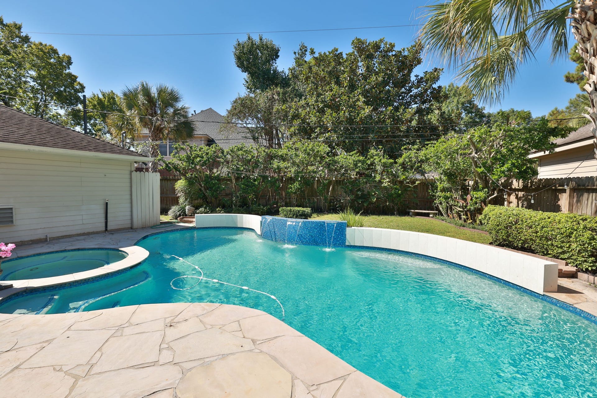 16107 Abberton Hill Drive, Spring, TX 77379 A perfect place to unwind sparkling pool, palm trees, and private fenced yard complete this inviting outdoor living space.