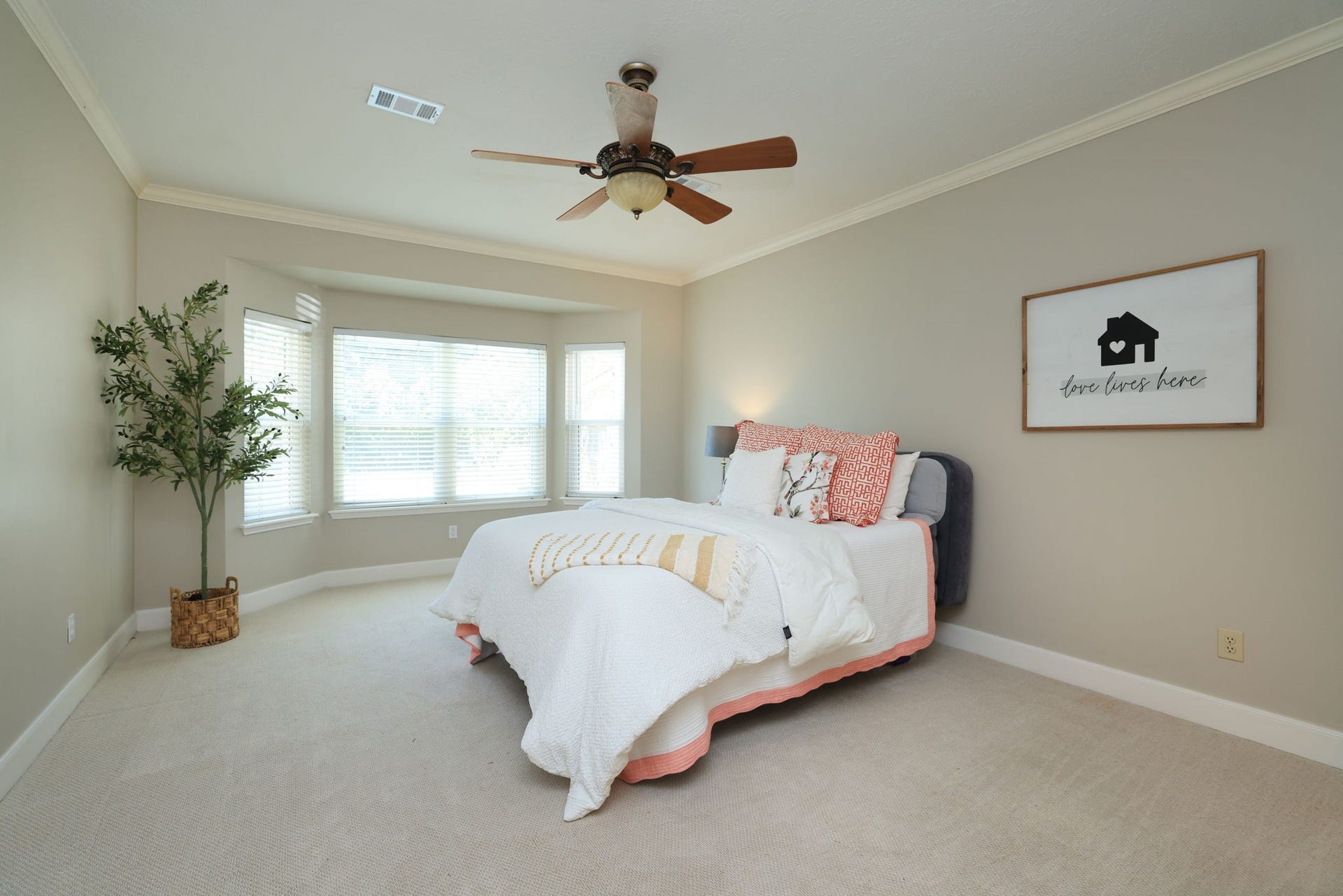 16107 Abberton Hill Drive, Spring, TX 77379 Serene primary retreat with bay window seating area, crown molding, and peaceful backyard views.
