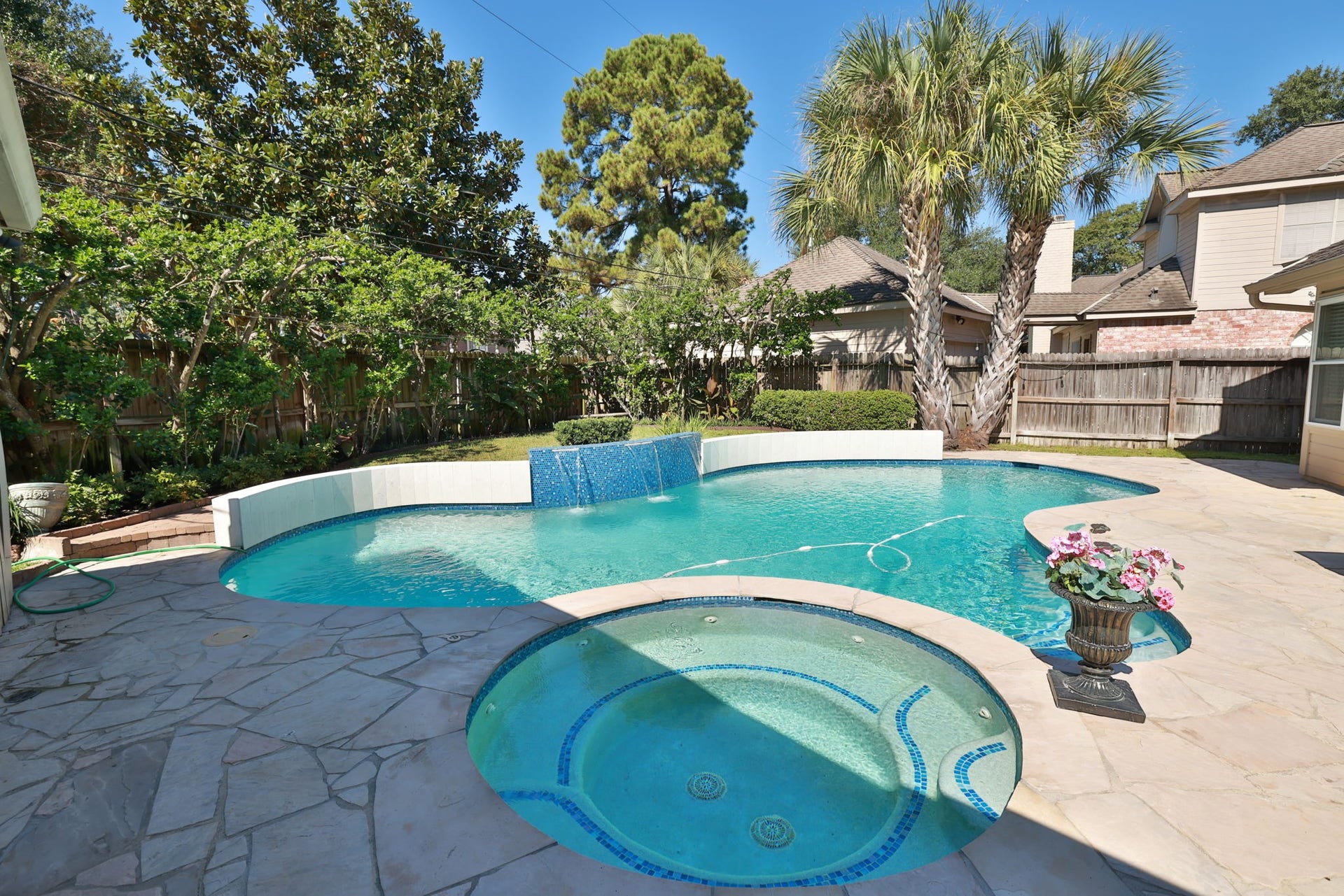 16107 Abberton Hill Drive, Spring, TX 77379 Cascading water feature flows gently over sparkling blue tiled raised deck ideal for relaxing or entertaining.