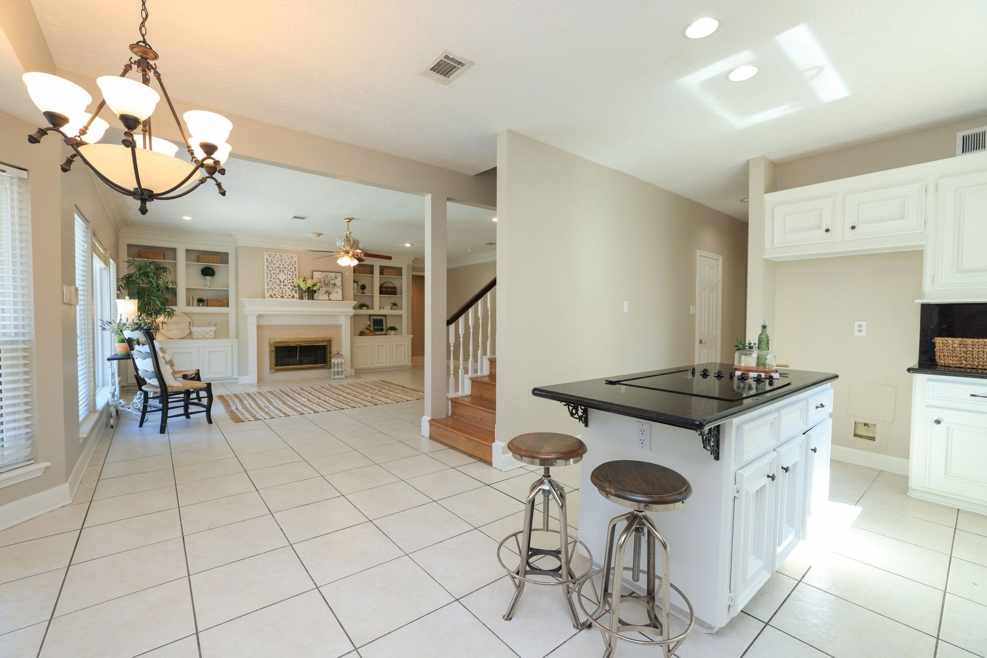 16107 Abberton Hill Drive, Spring, TX 77379 Kitchen opens directly to the family room, both with tile floors and island seating.
