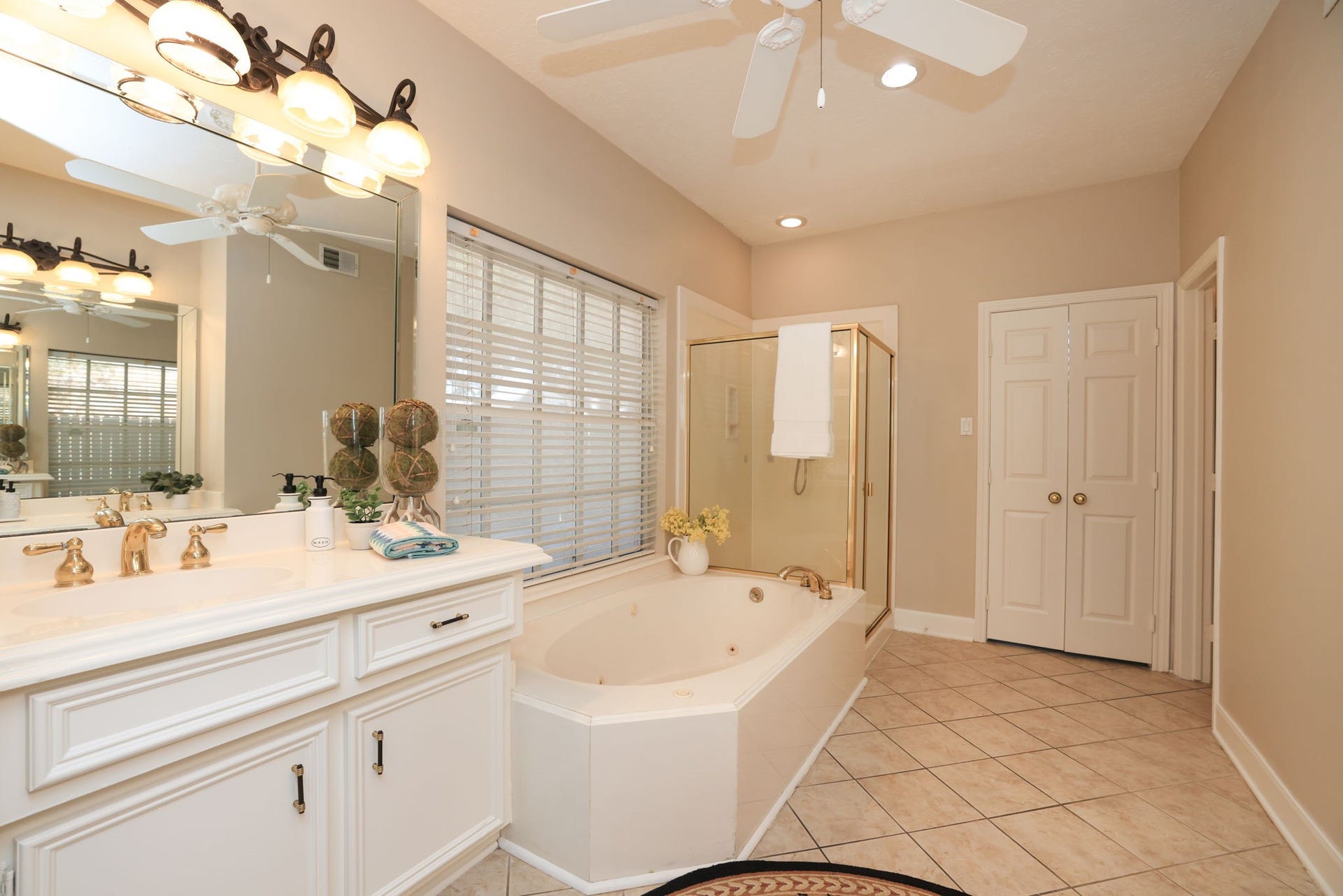 16107 Abberton Hill Drive, Spring, TX 77379 Generous vanity space with updated lighting, mirrors, and a spa-inspired layout.