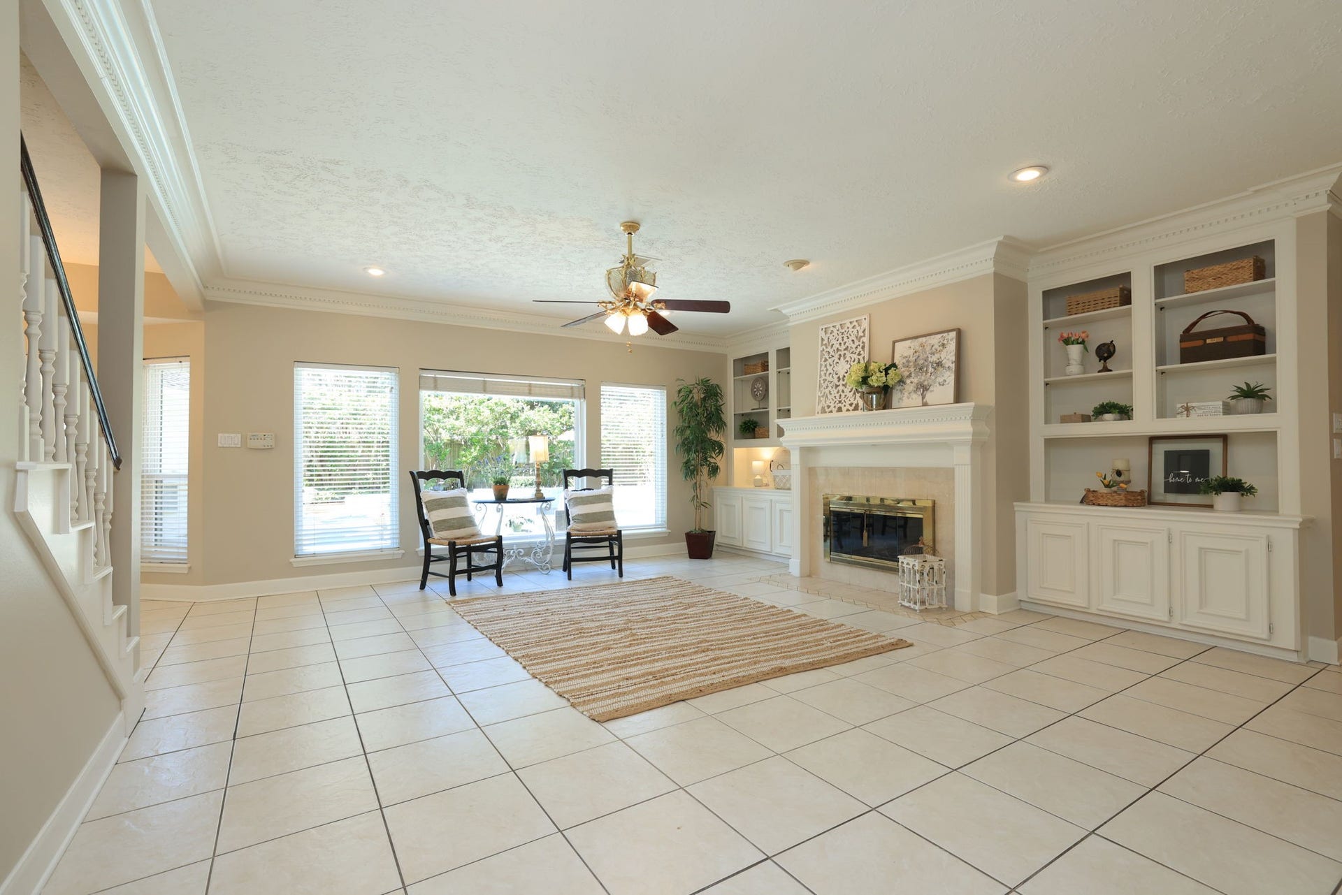 16107 Abberton Hill Drive, Spring, TX 77379 Bright and inviting family room with custom built-ins, crown molding, and a gas fireplace as the centerpiece.