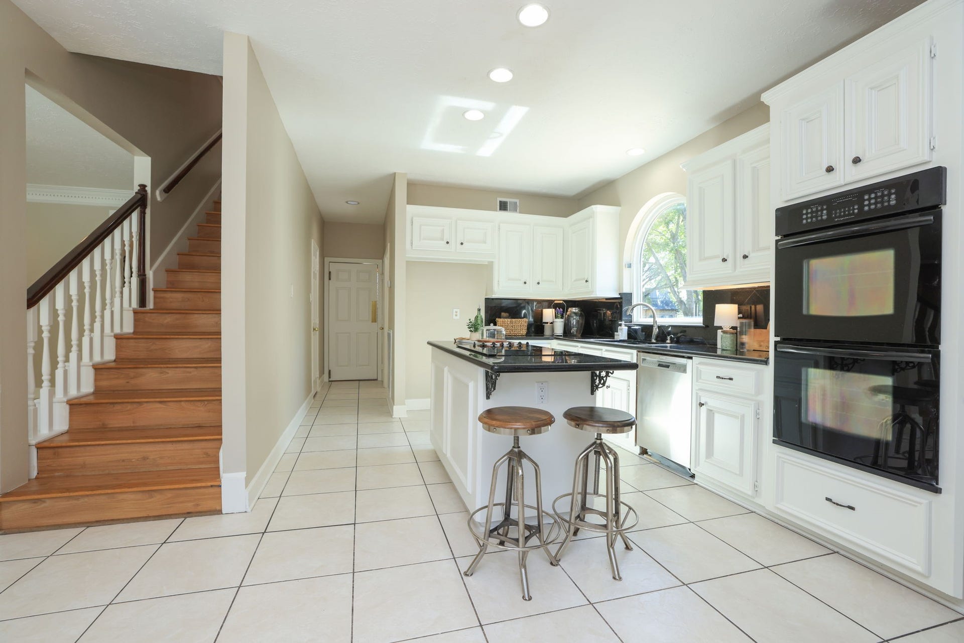 16107 Abberton Hill Drive, Spring, TX 77379 Light-filled kitchen with large island, stainless appliances, and seamless access to the upstairs and utility areas.