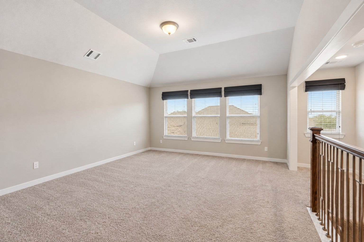 This spacious game room features plush carpet, and bright natural light - perfect for movie nights, game days, or just hanging out. Let the good times begin!