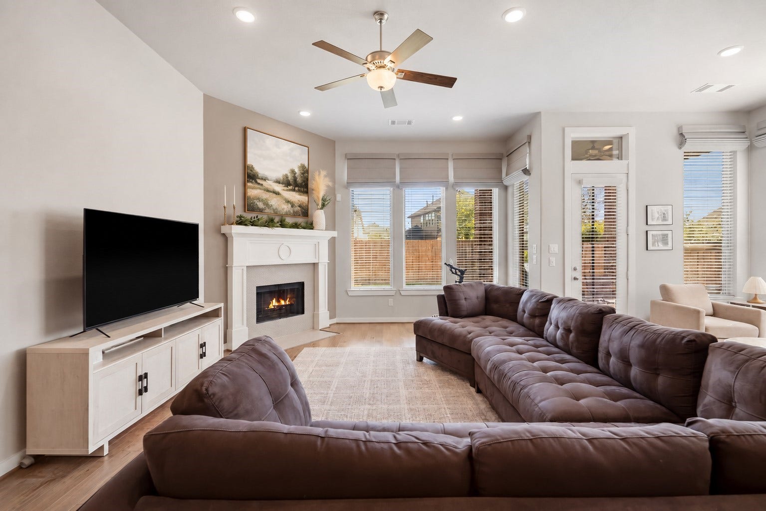 The open flow connects effortlessly to the kitchen and dining areas, making it ideal for those who appreciate refined, modern living with a timeless touch.