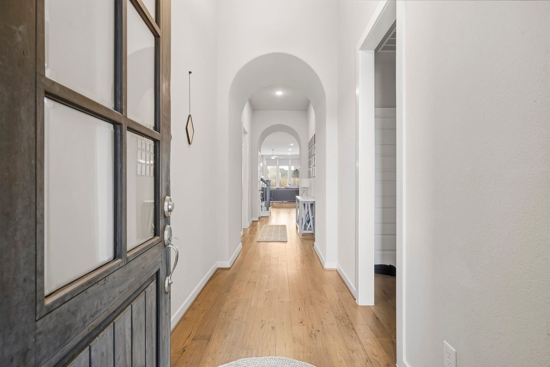 Walking in, you find a bright entryway with high ceilings and beautiful light wood flooring that continues throughout the first floor in the main living areas making it easy to clean and maintain.