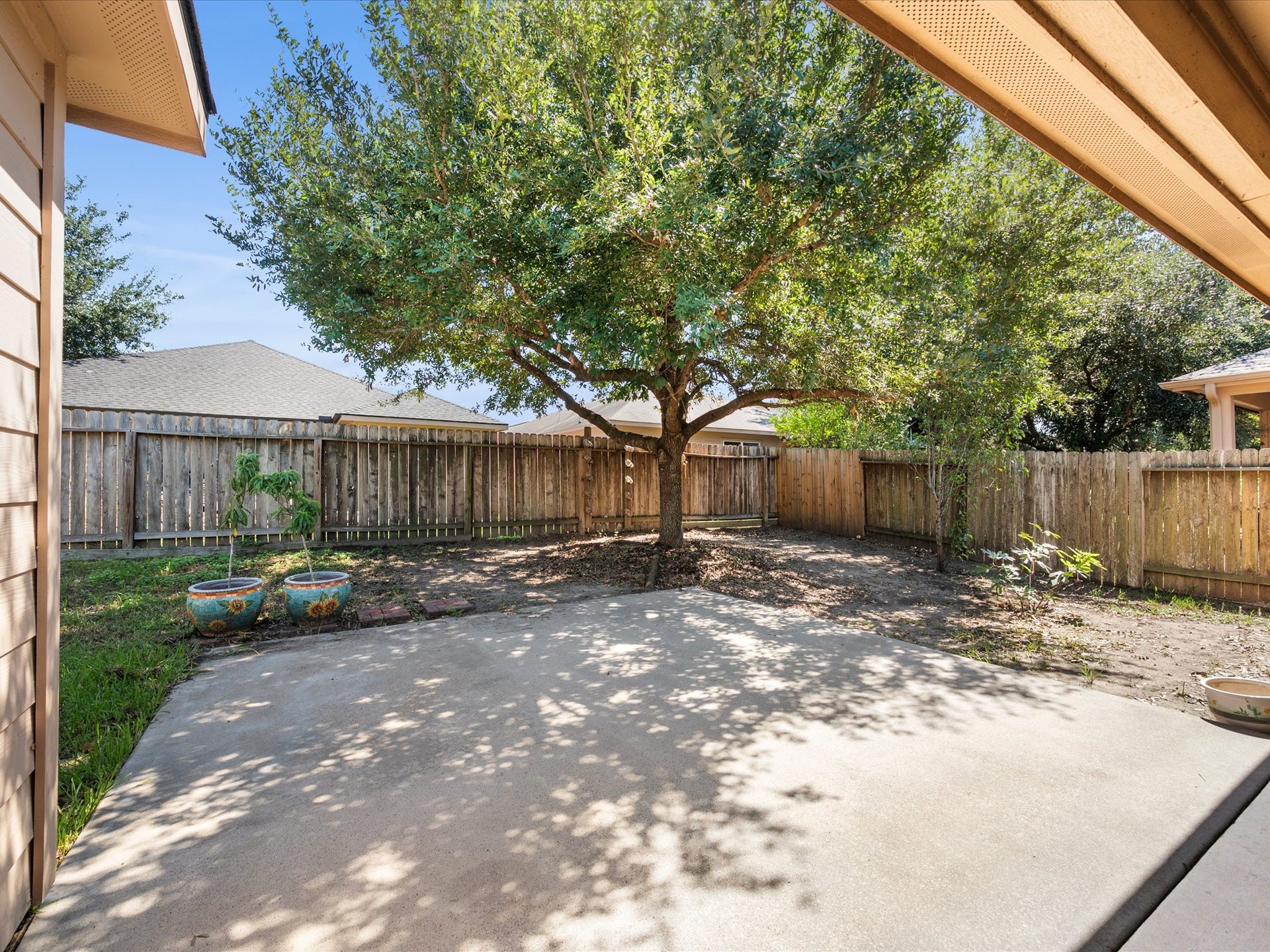 305 Pine Mist Lane, Conroe, TX 77304 Enjoy the shade of a beautiful mature tree overlooking the fenced backyard and patio.