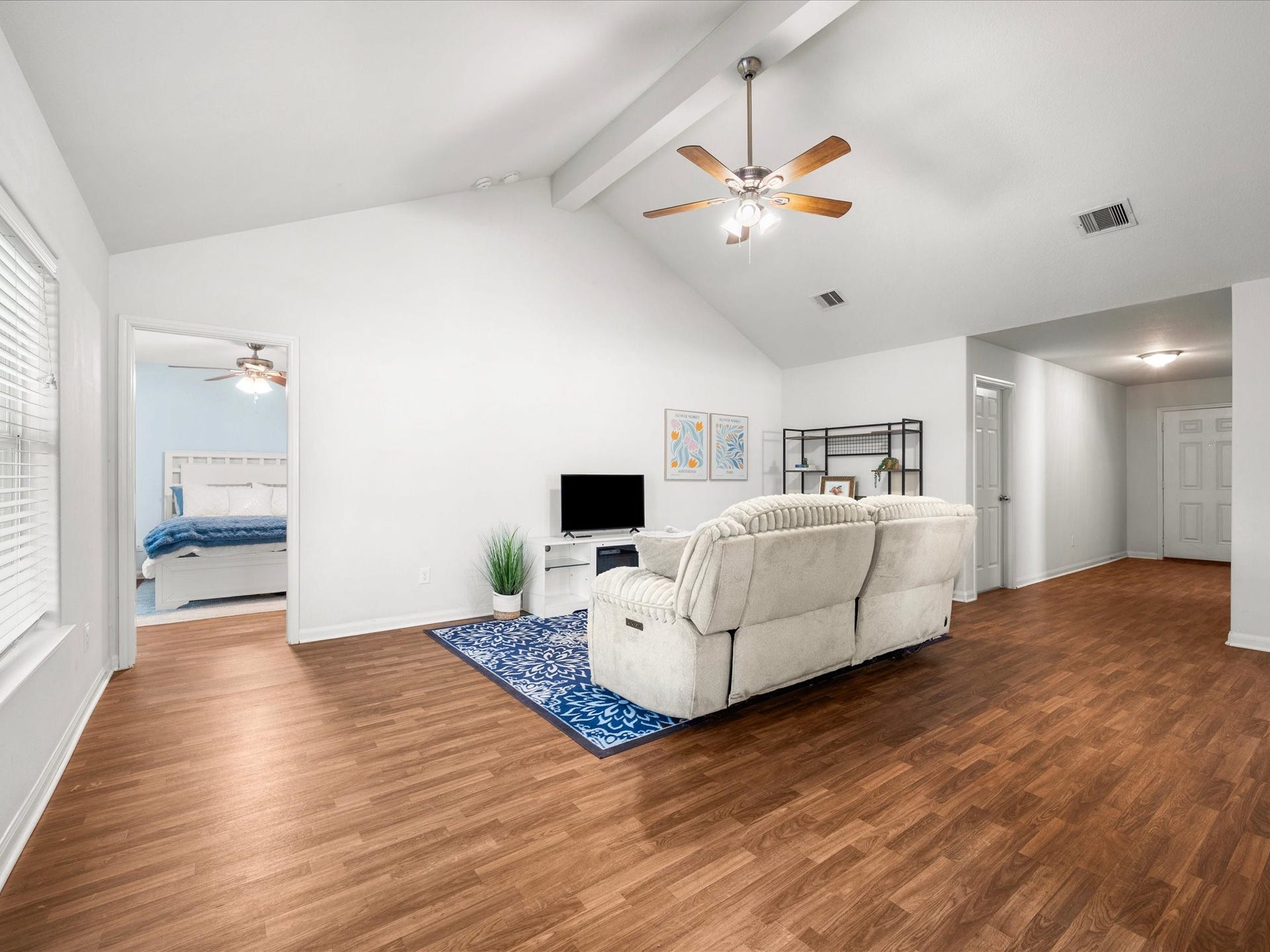 305 Pine Mist Lane, Conroe, TX 77304 Vaulted ceilings and a new ceiling fan create an open, airy living space. Natural light fills the living room through a large window overlooking the backyard.