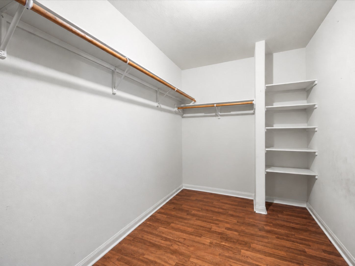 305 Pine Mist Lane, Conroe, TX 77304 A spacious walk in closet with hanging space and built in shelving for organized storage.