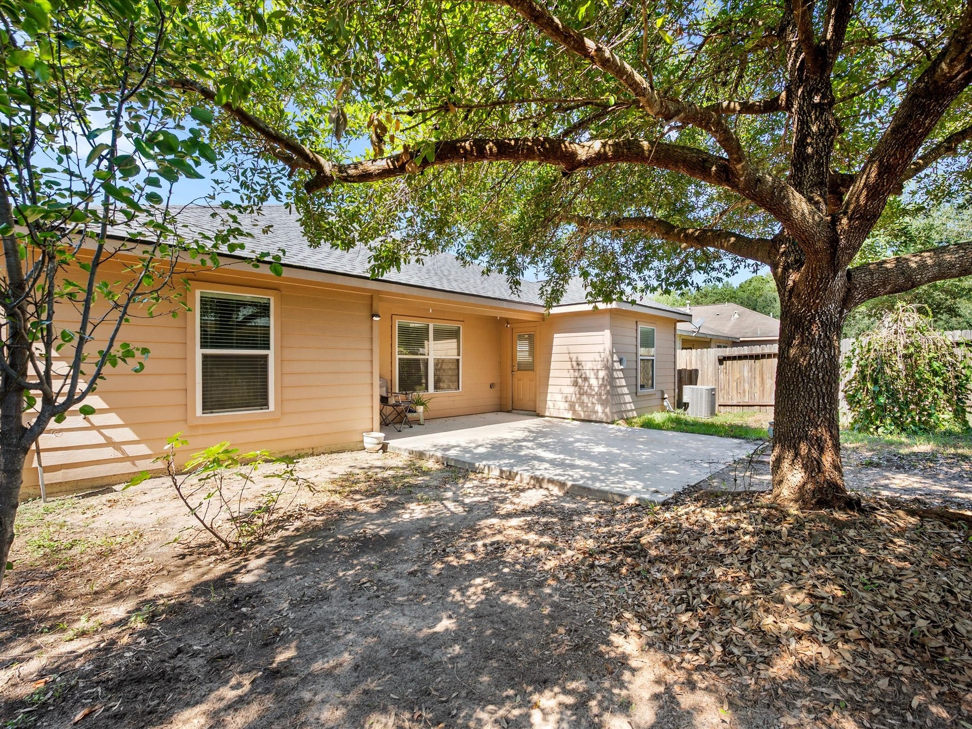305 Pine Mist Lane, Conroe, TX 77304 A spacious patio and mature shade tree create a wonderful setting for outdoor enjoyment.