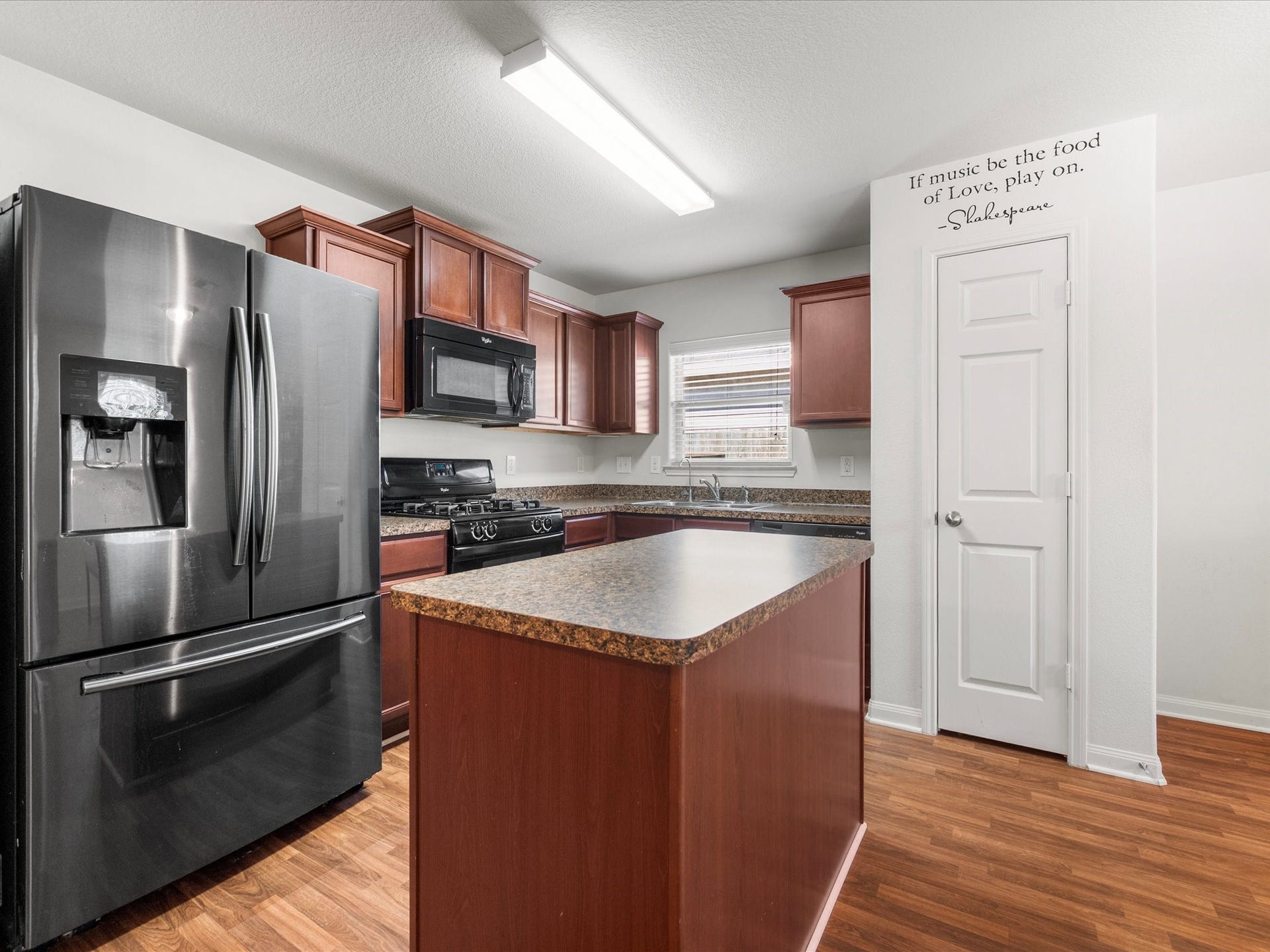 305 Pine Mist Lane, Conroe, TX 77304 The kitchen offers ample cabinetry, a gas range, pantry and a convenient window above the sink.