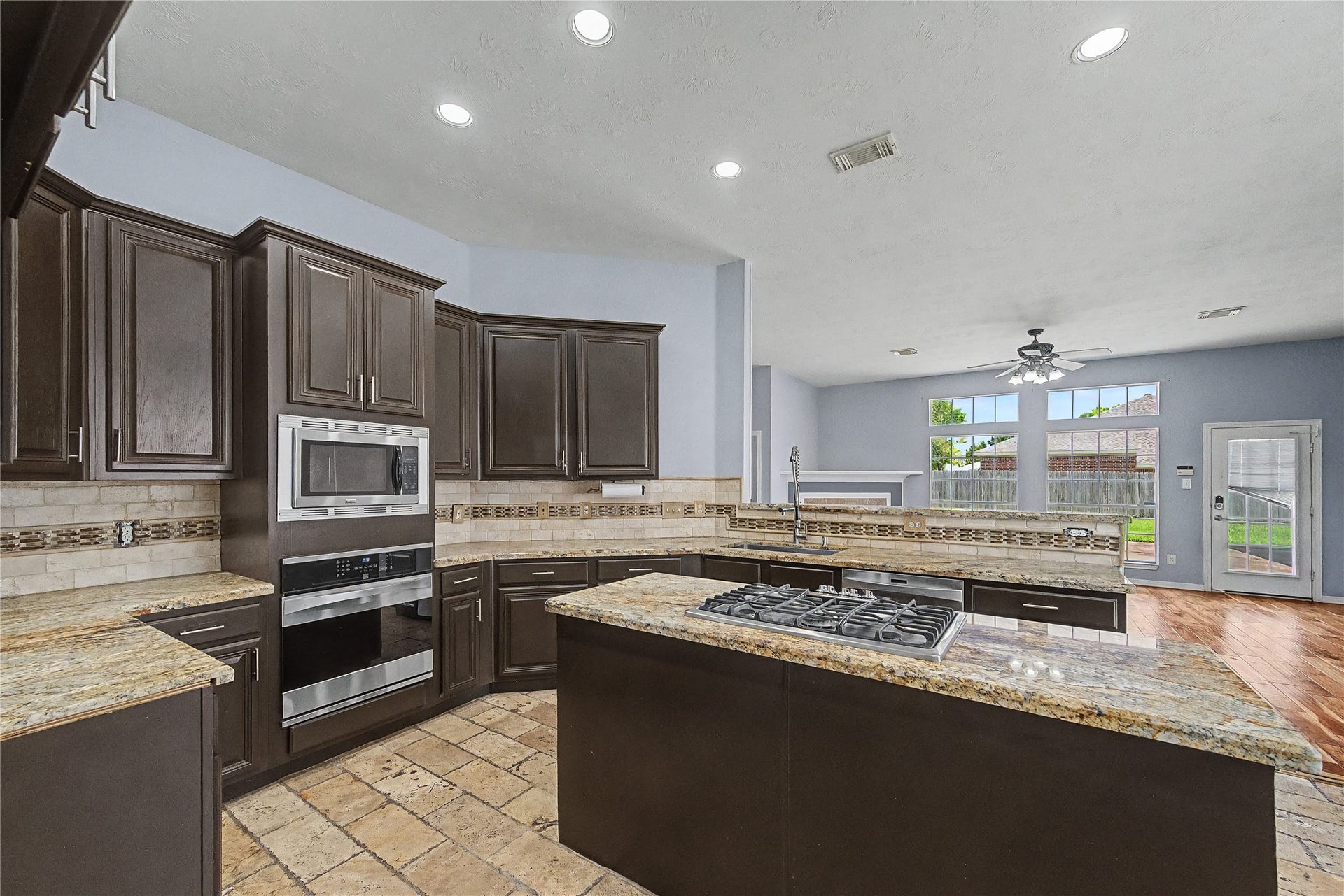 3615 Turtle Cove Drive, Pasadena, TX 77505 LARGE KITCHEN WITH PLENTY OF CABINET SPACE, GRANITE COUNTERTOPS, STAINLESS BUILT-IN OVEN & MICROWAVE, GAS COOKTOP IN THE KITCHEN ISLAND