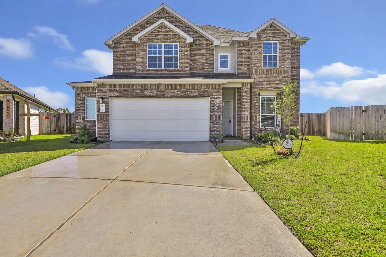 Welcome to your dream home! This stunning brick house features modern design, a spacious driveway, and a lush lawn. Perfect for family living.