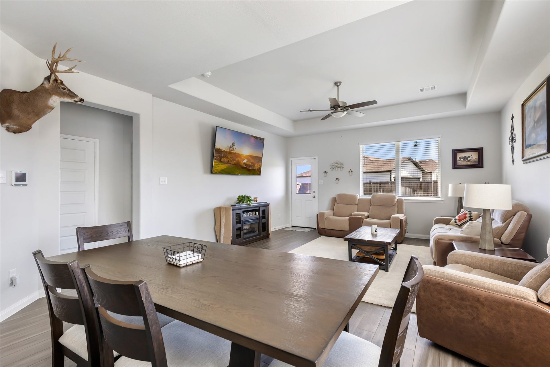 Elegant tray ceilings enhance the family room's charm.