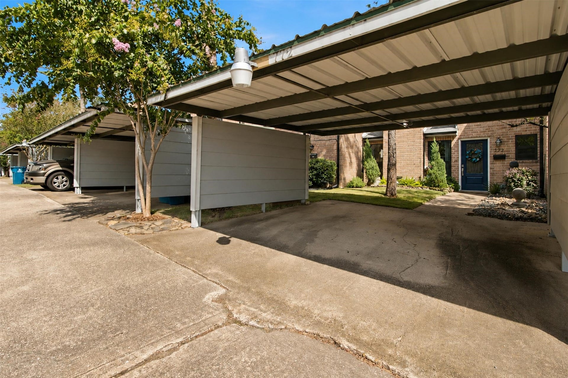Spacious covered parking and extended driveway provide ample parking.