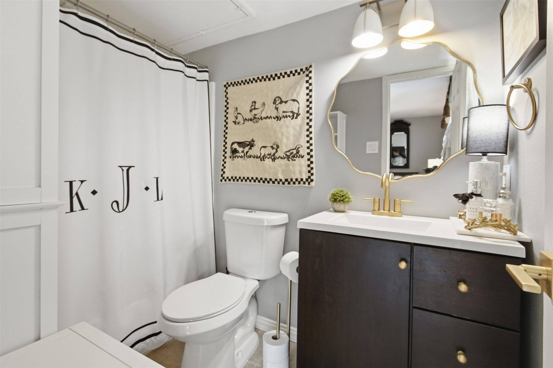 Updated full bathroom featuring a modern vanity and tasteful finishes.