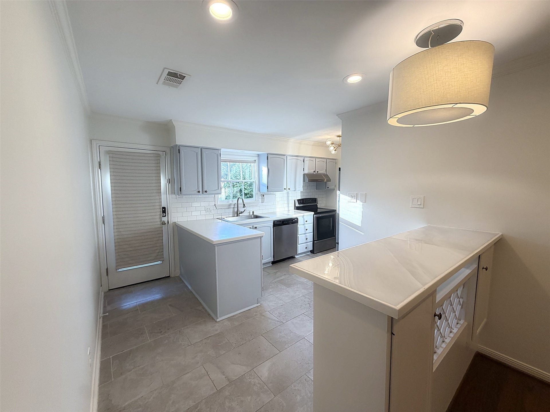 View of the kitchen and backyard exit door from the dining area