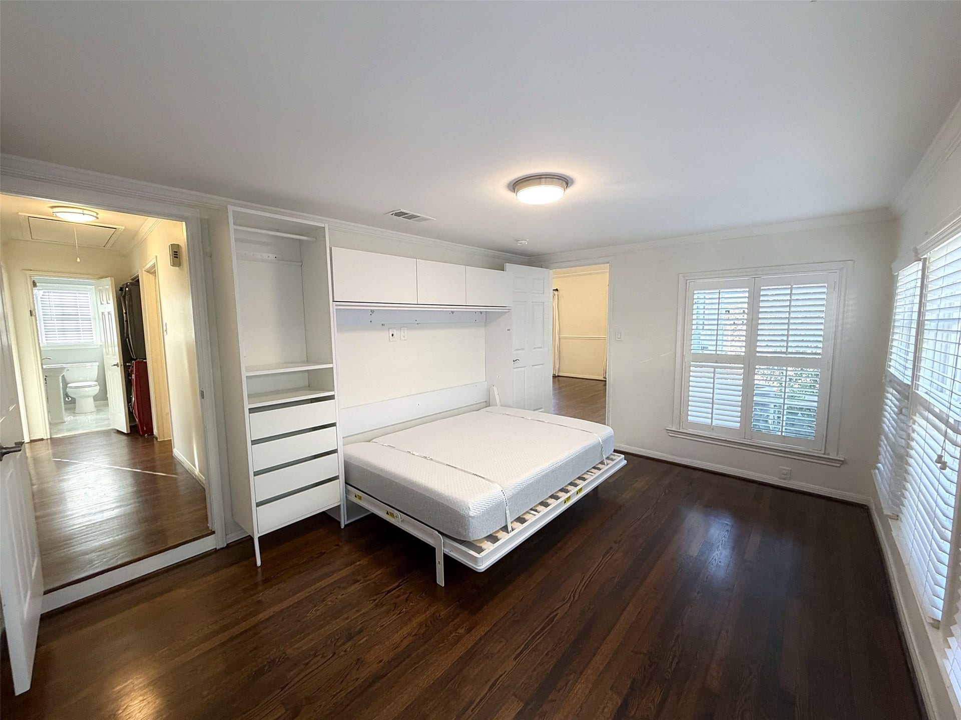 The built-in Murphy bed with integrated drawers and shelving for the weekend visitor.