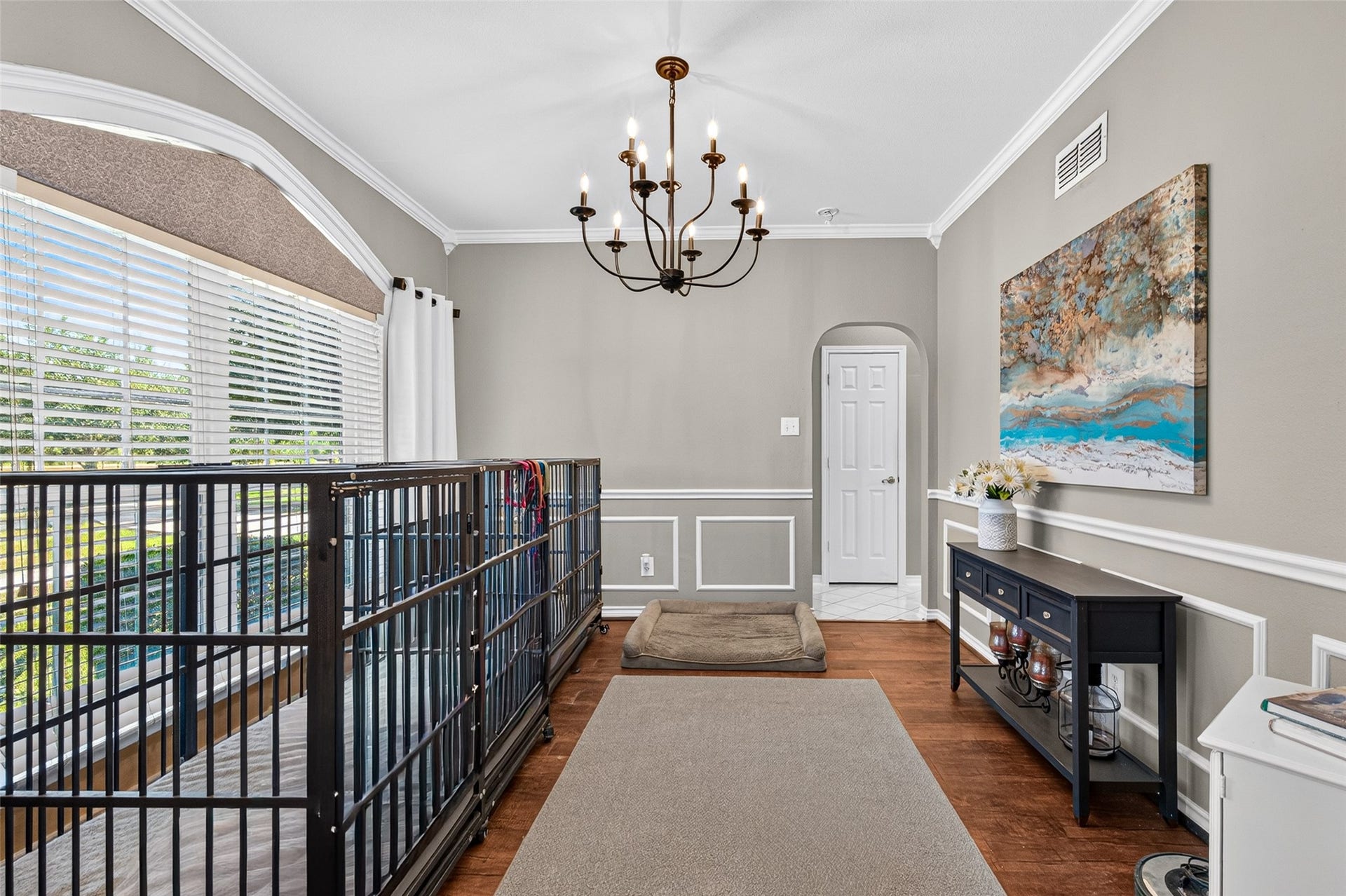 Versatile dining space with detailed wall trim and open view toward the staircase