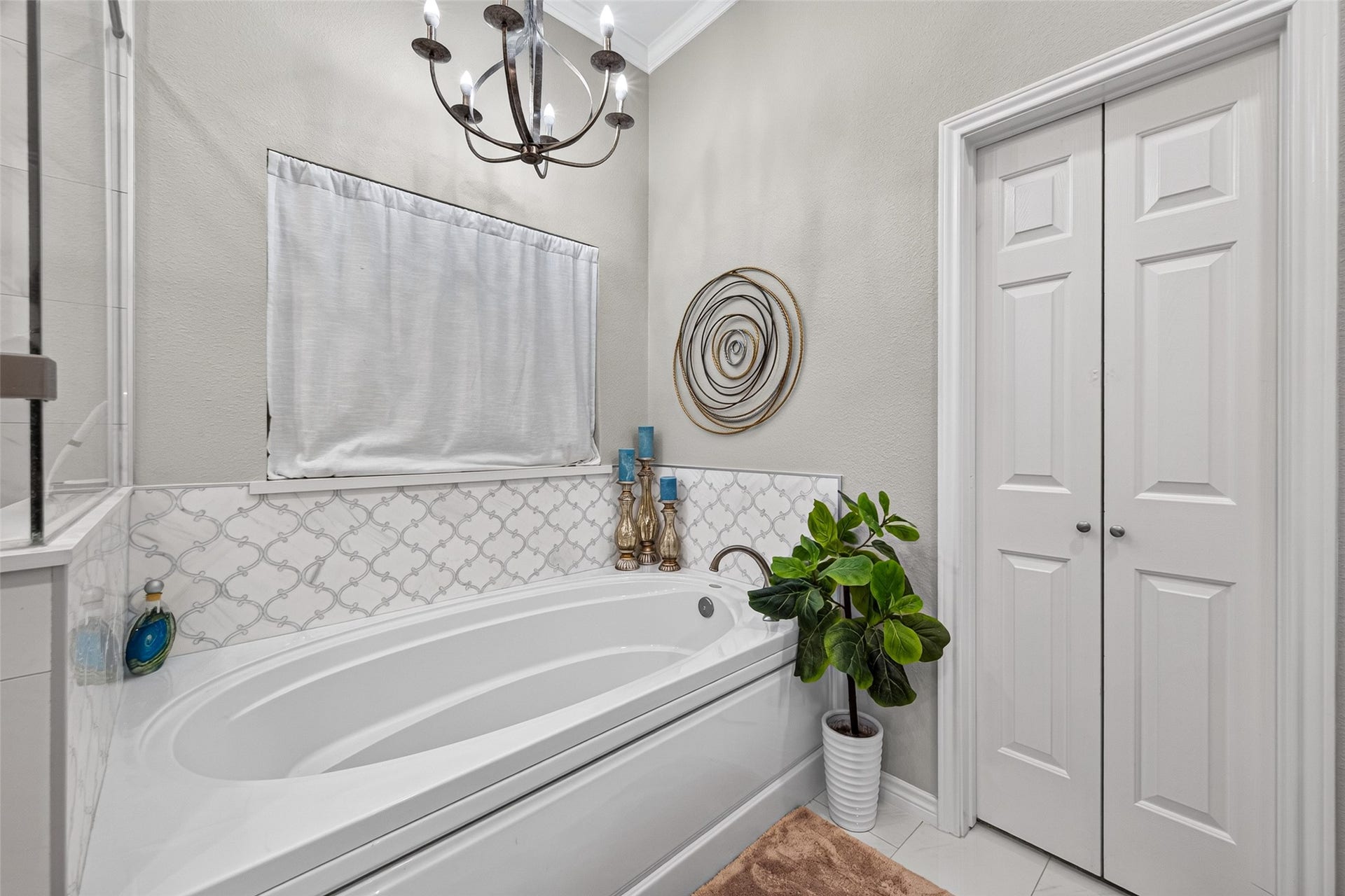Oversize soaking tub with ornamental mother of pearl backsplash