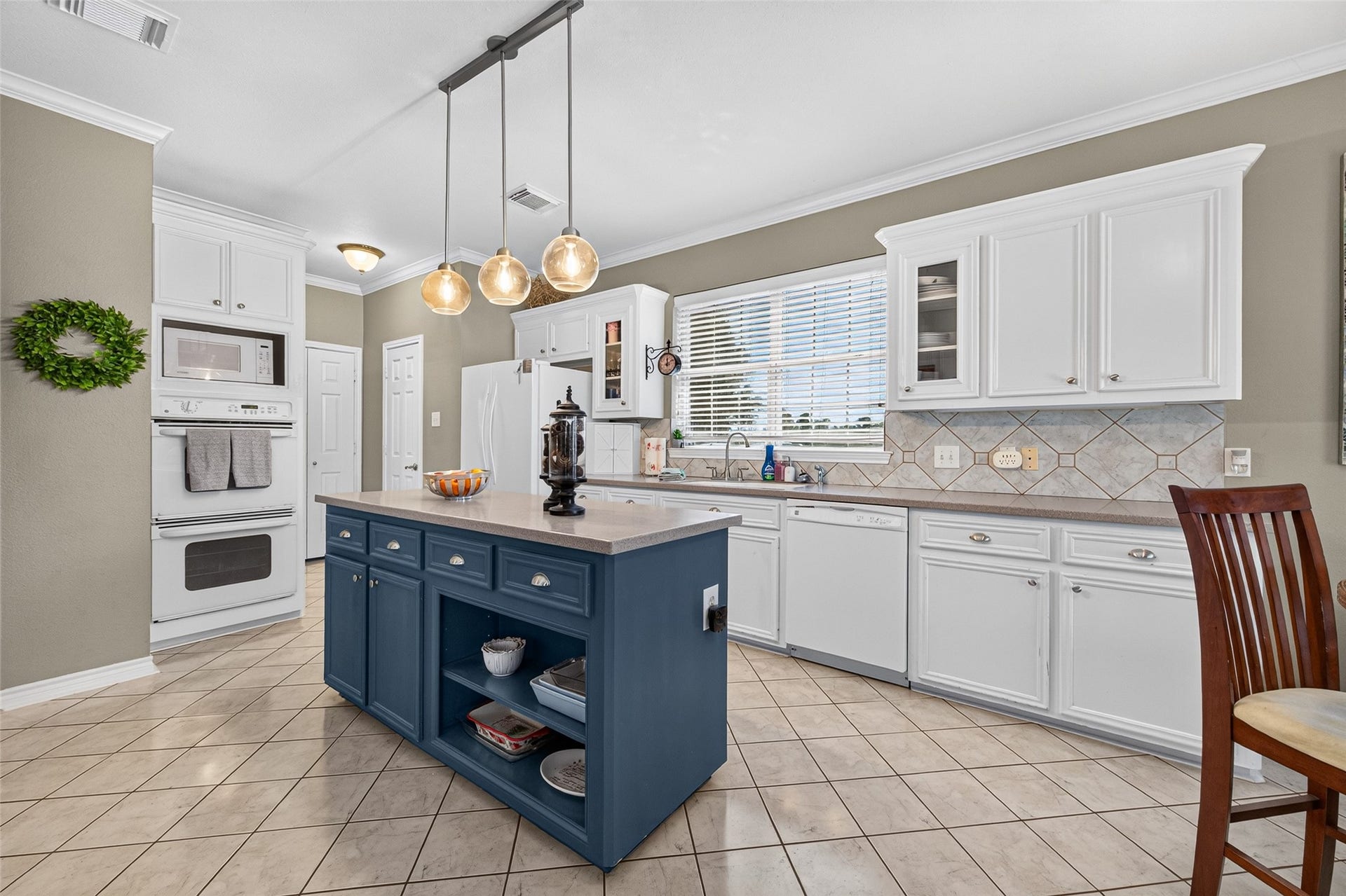 Well-appointed kitchen offering a functional layout, ample storage and large central island