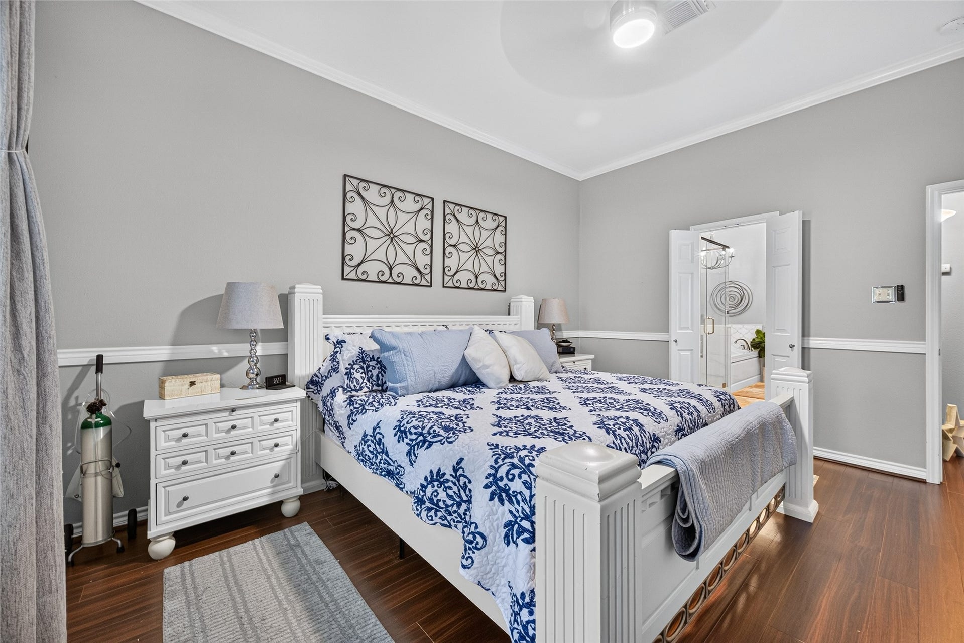 Primary bedroom has laminate flooring and space for a desk or sitting area