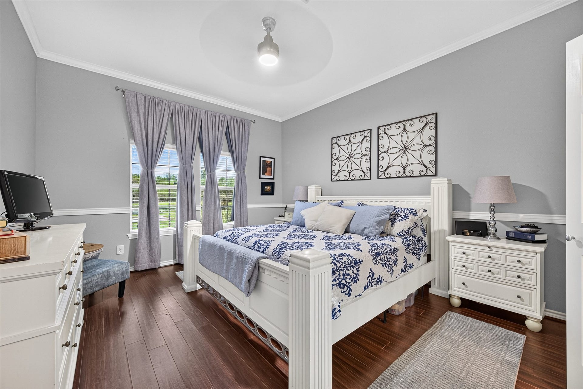 Downstairs primary bedroom has an elevated ceiling and large window overlooking the backyard