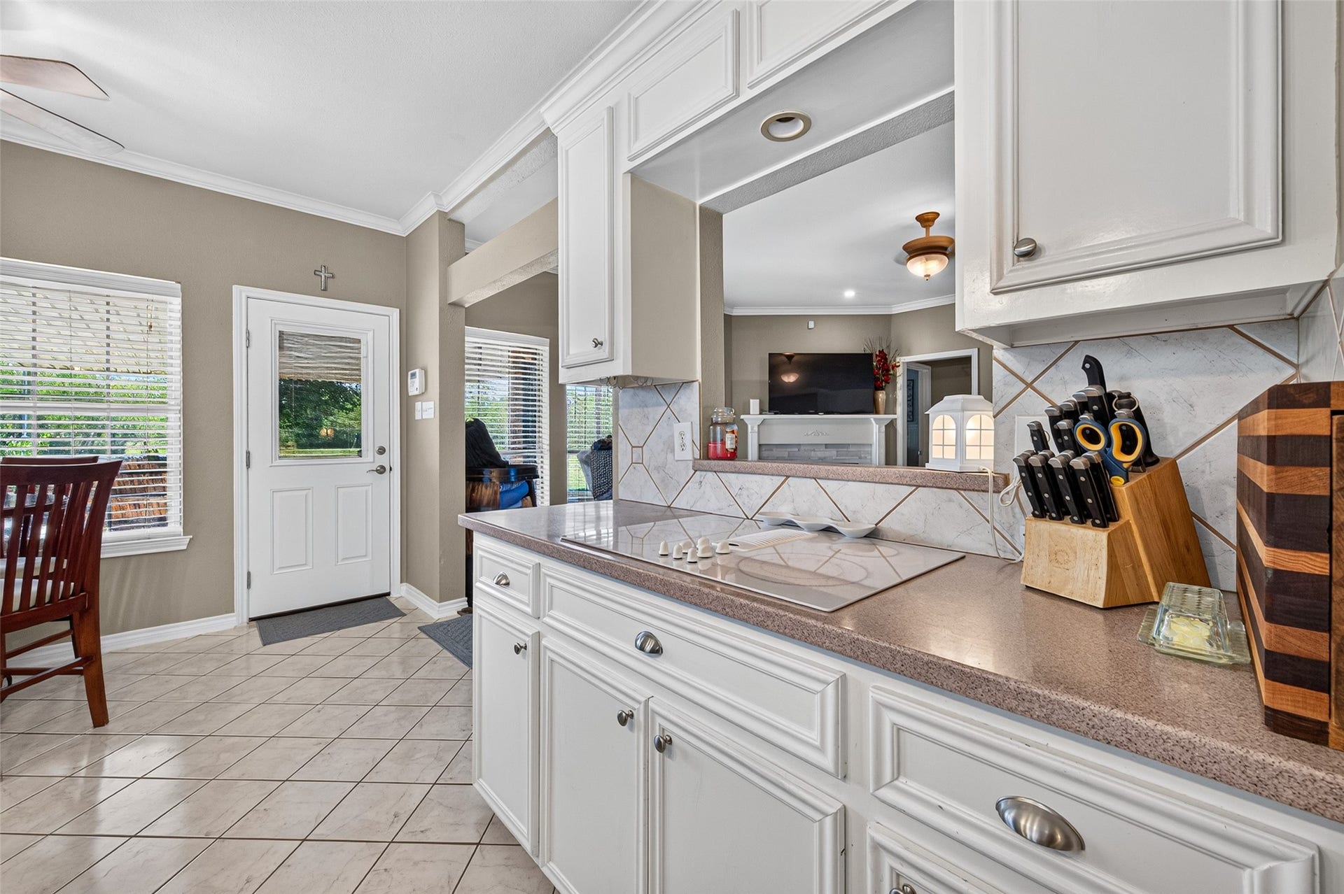 Another view of kitchen at cooktop with opening into living room