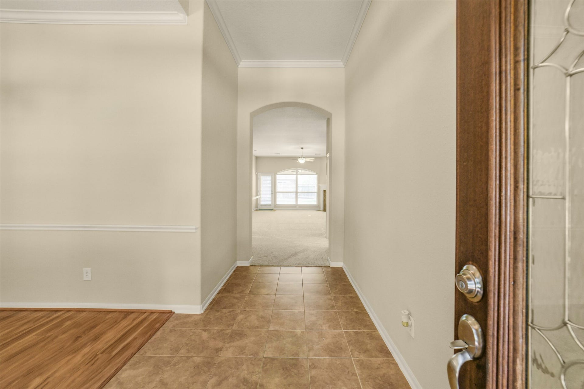 Inviting entryway leads to a bright, open living area with large windows.