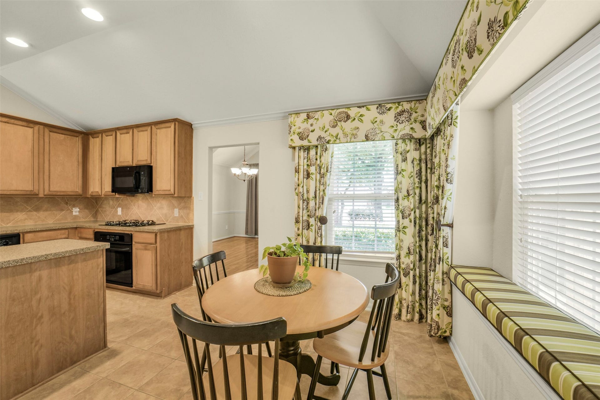 Bright and inviting cozy breakfast nook with a bay window and cushioned seating.