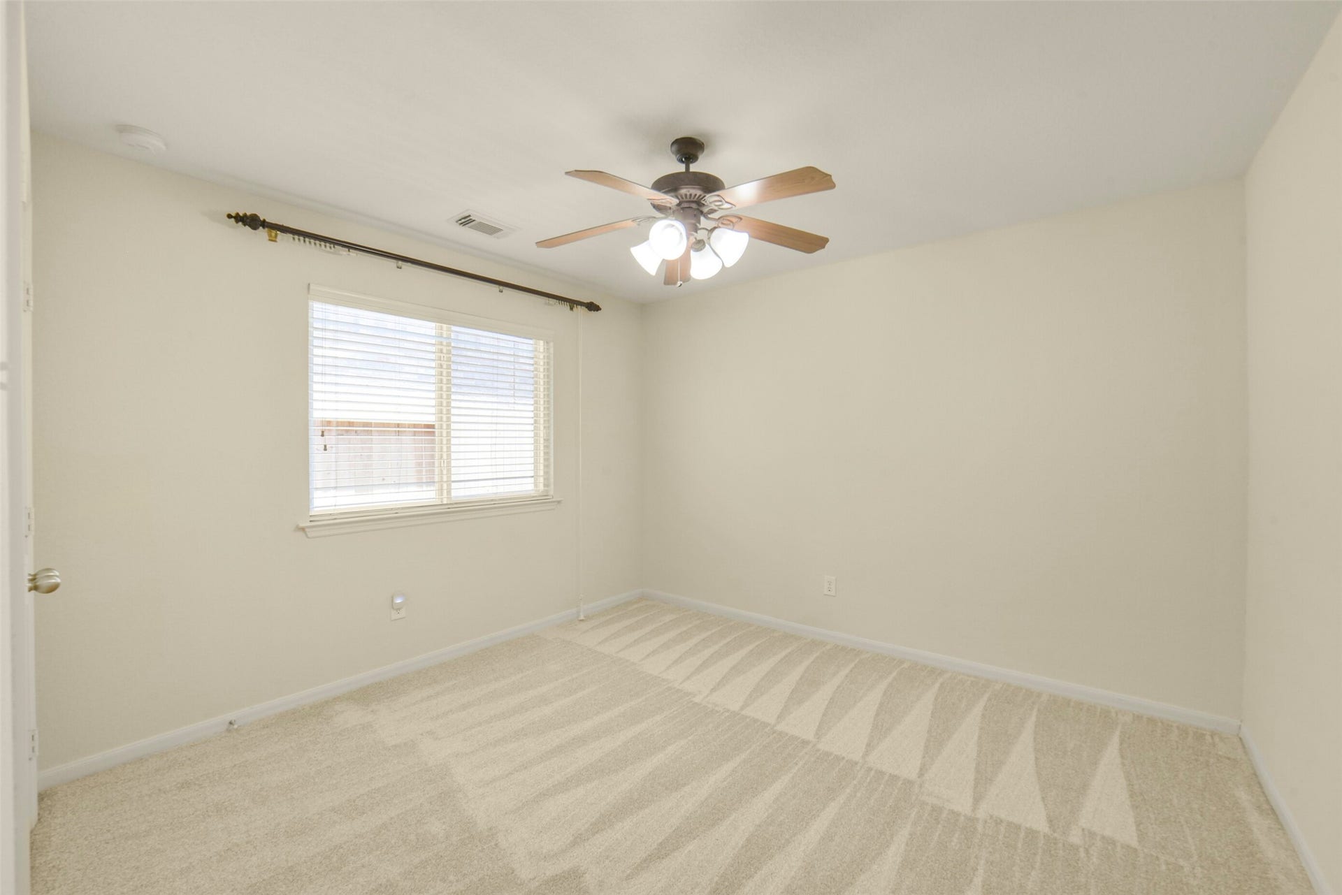 Secondary bedroom with a ceiling fan and dual closets, offering ample storage and comfort.