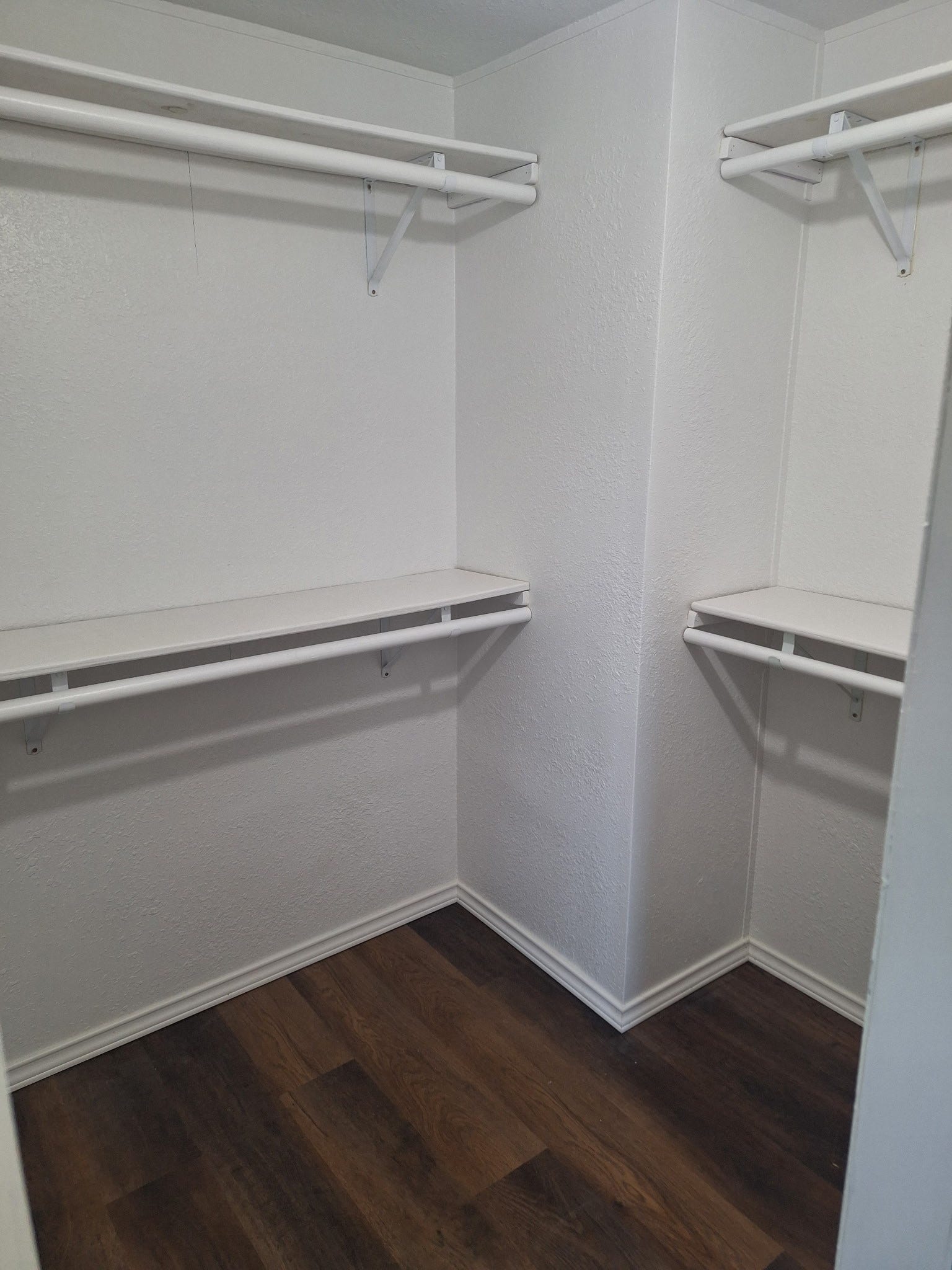 1308 County Road 159, Alvin, TX 77511 Spacious walk-in closet featuring built-in shelving and hanging space for convenient storage.
