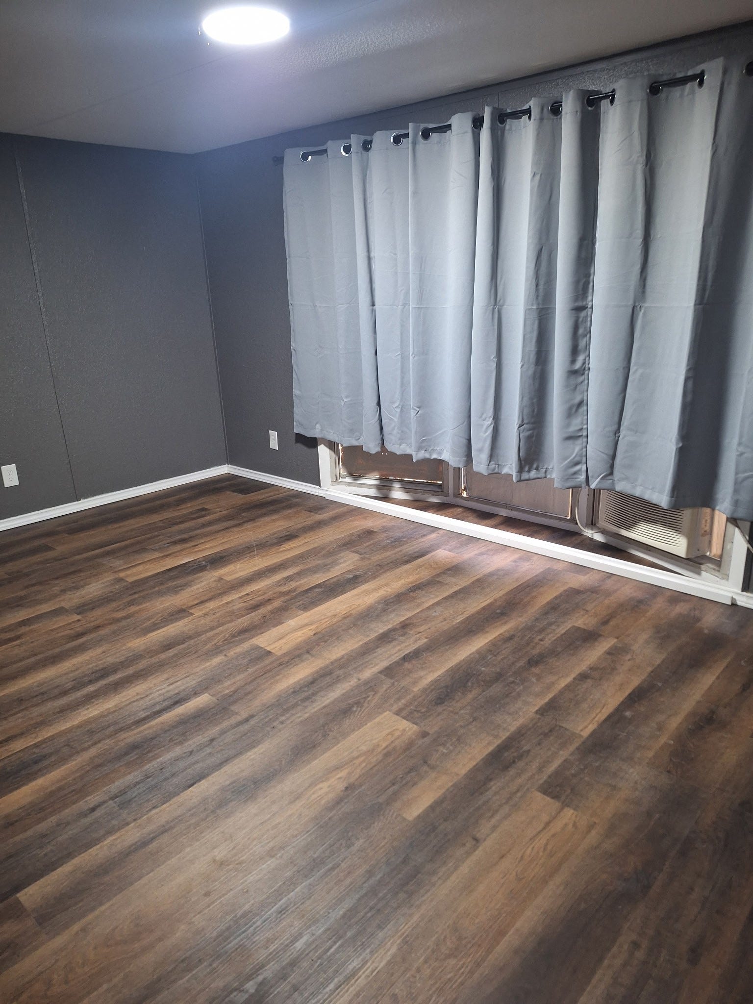 1308 County Road 159, Alvin, TX 77511 Additional bedroom featuring attractive wood-look flooring, natural lighting, and neutral finishes.