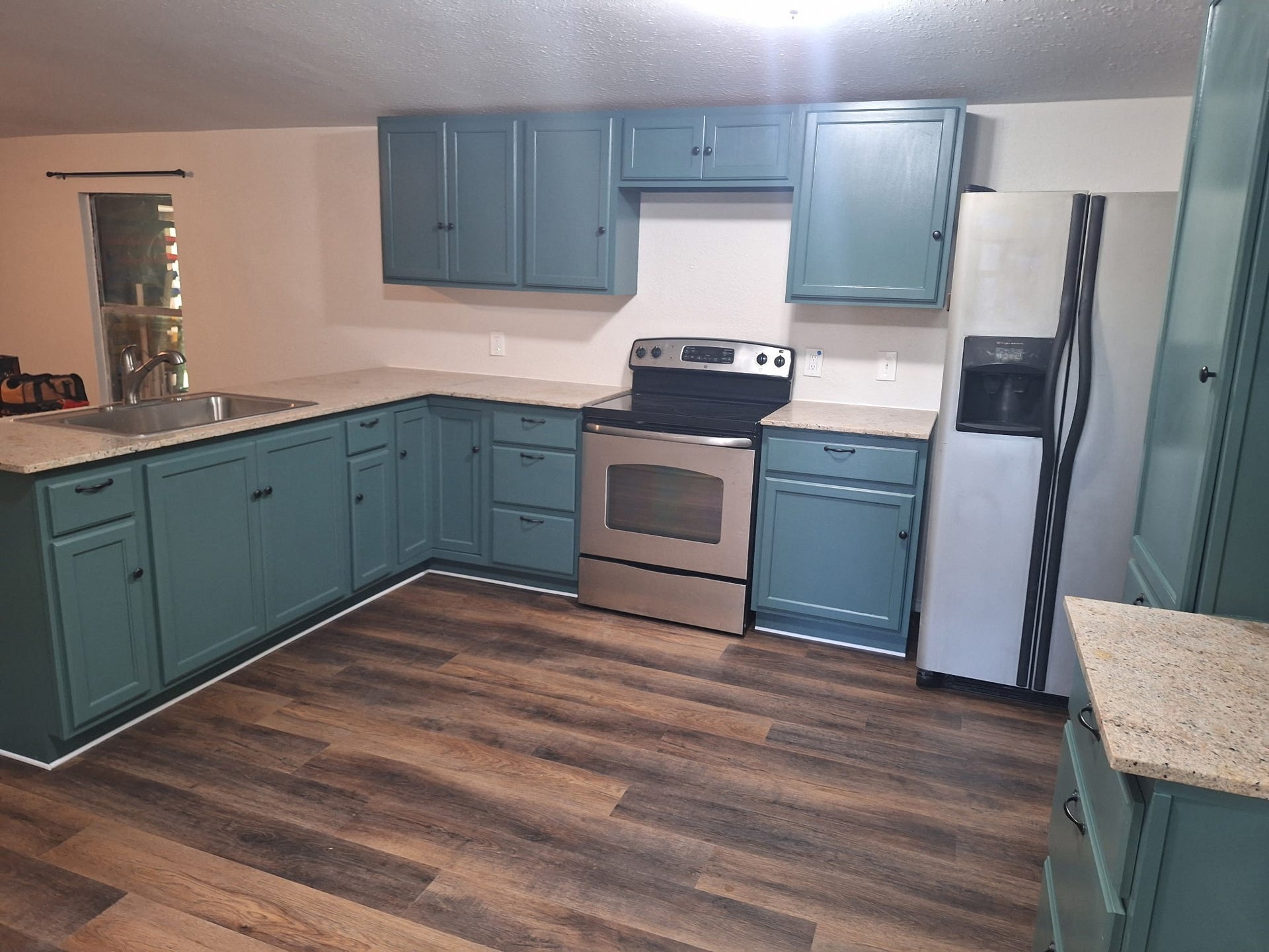 1308 County Road 159, Alvin, TX 77511 Functional kitchen featuring ample cabinetry, generous counter space, and stainless steel appliances.