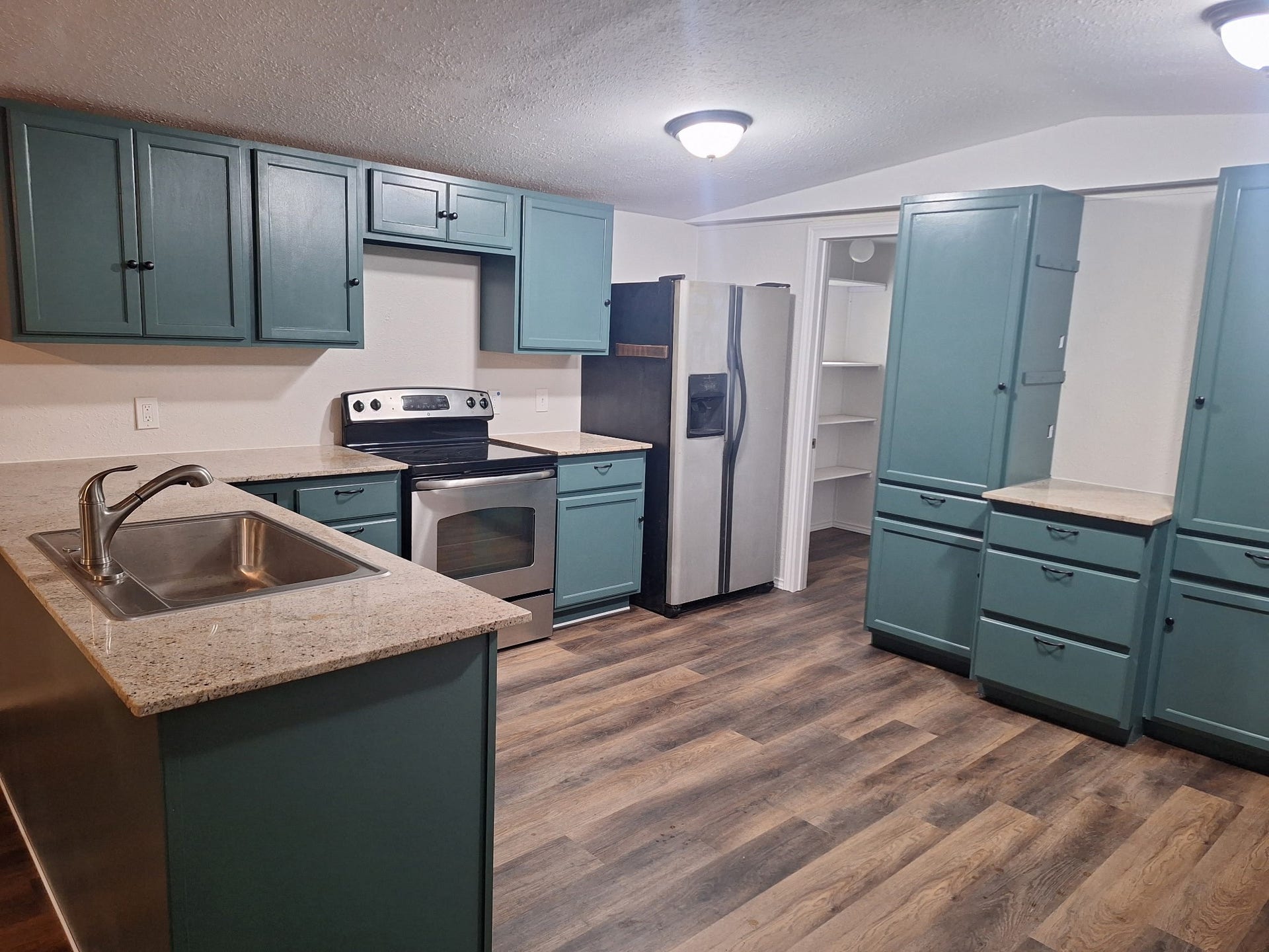 1308 County Road 159, Alvin, TX 77511 Another view of the kitchen showcasing abundant cabinetry, counter space, and an open layout.