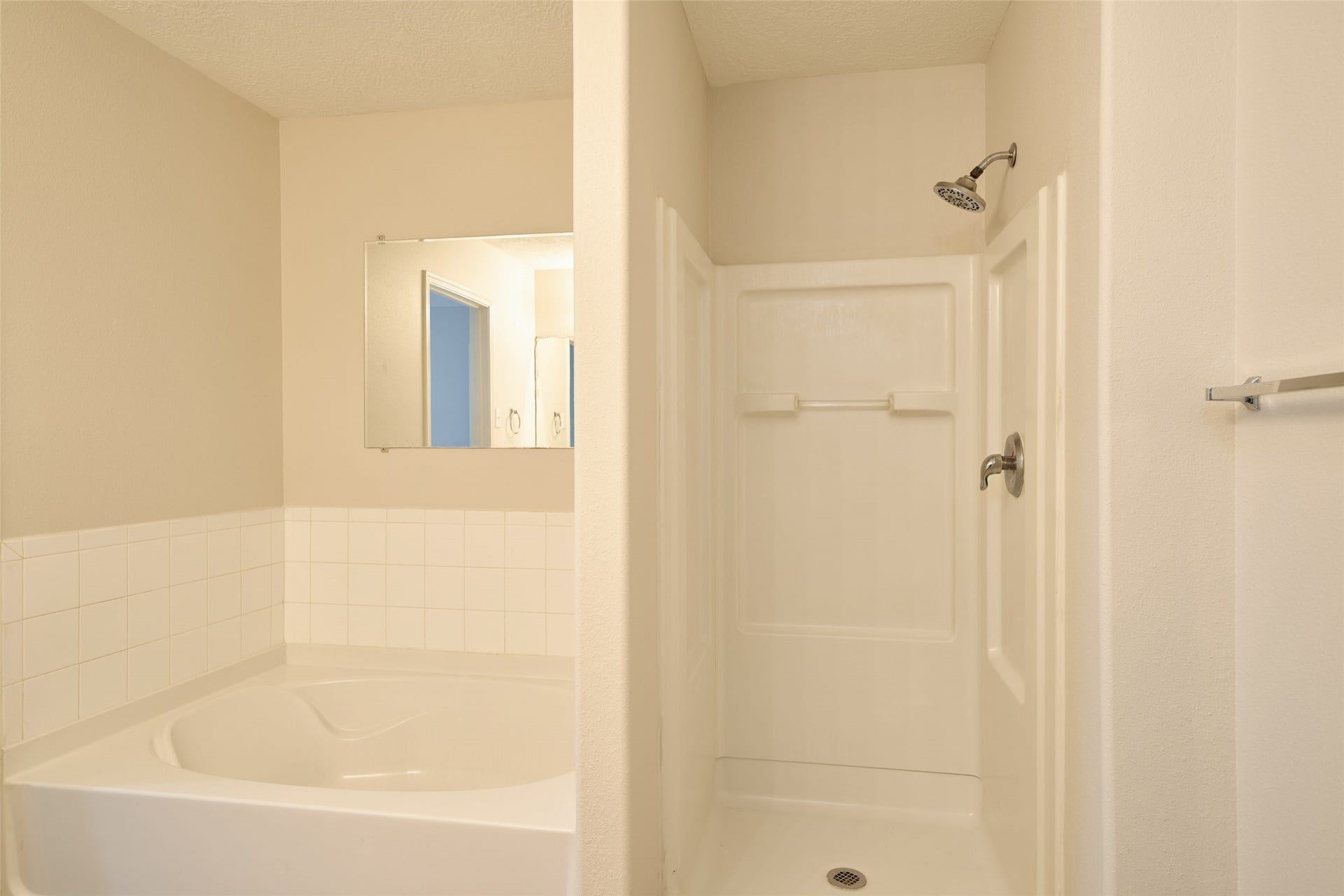 Primary bathroom has separate large tub and stand up shower