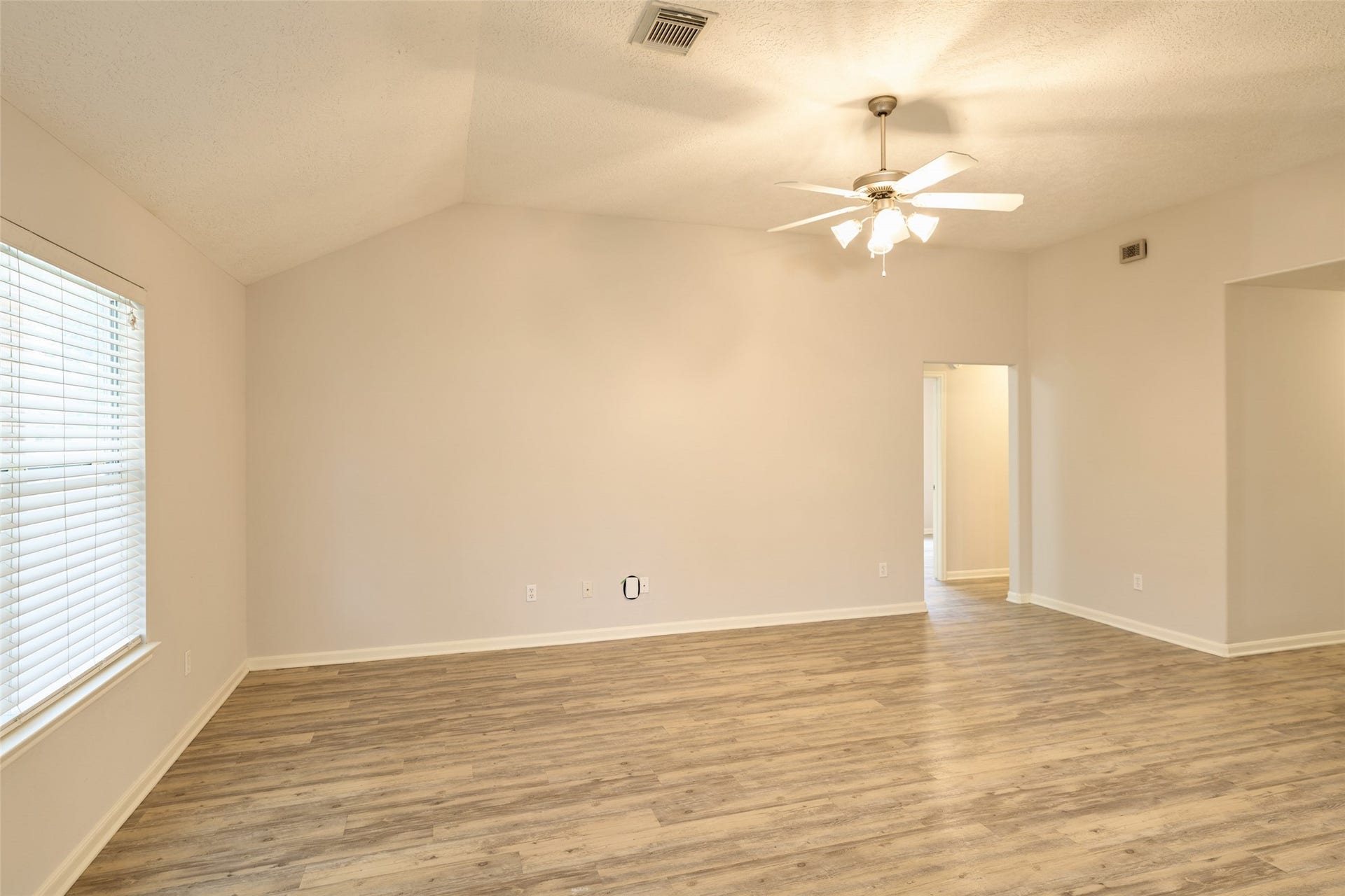 View of living room towards hallway leading to secondary bedrooms.
