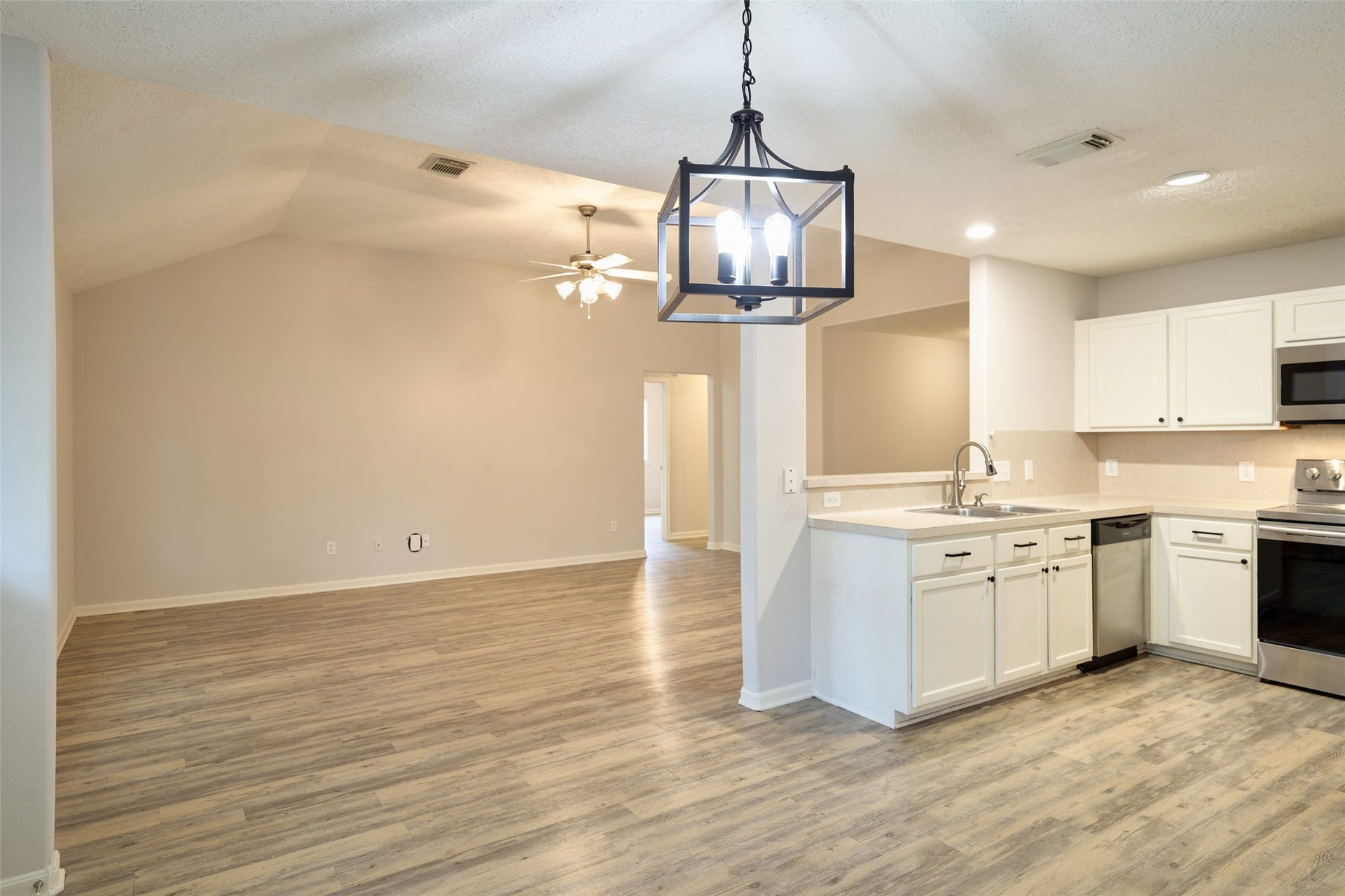 View of living room and kitchen from breakfast room.