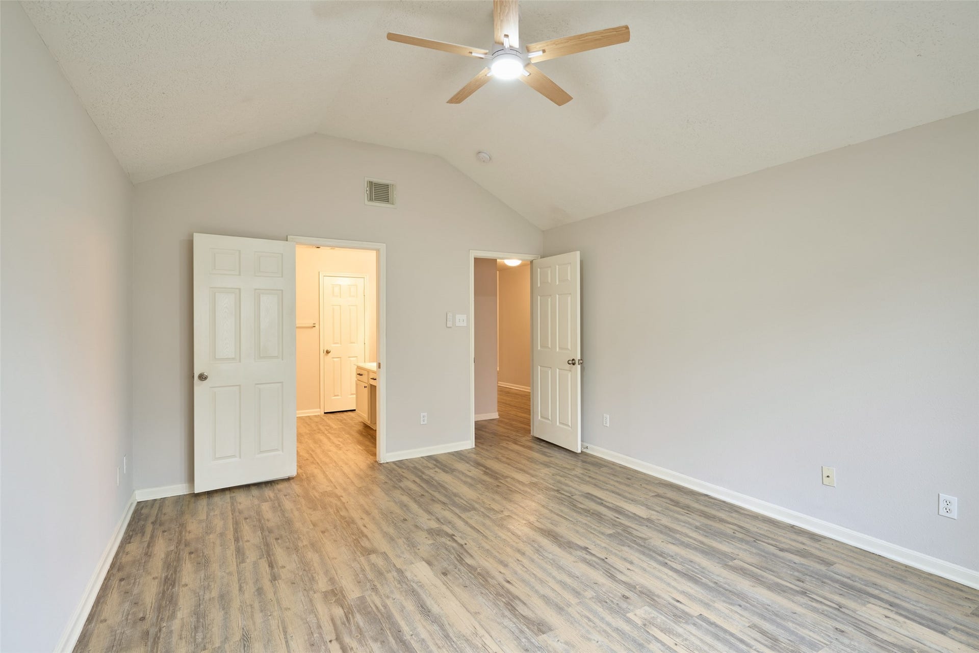 Primary bedroom has high ceiling and plenty of room for your king size bed!