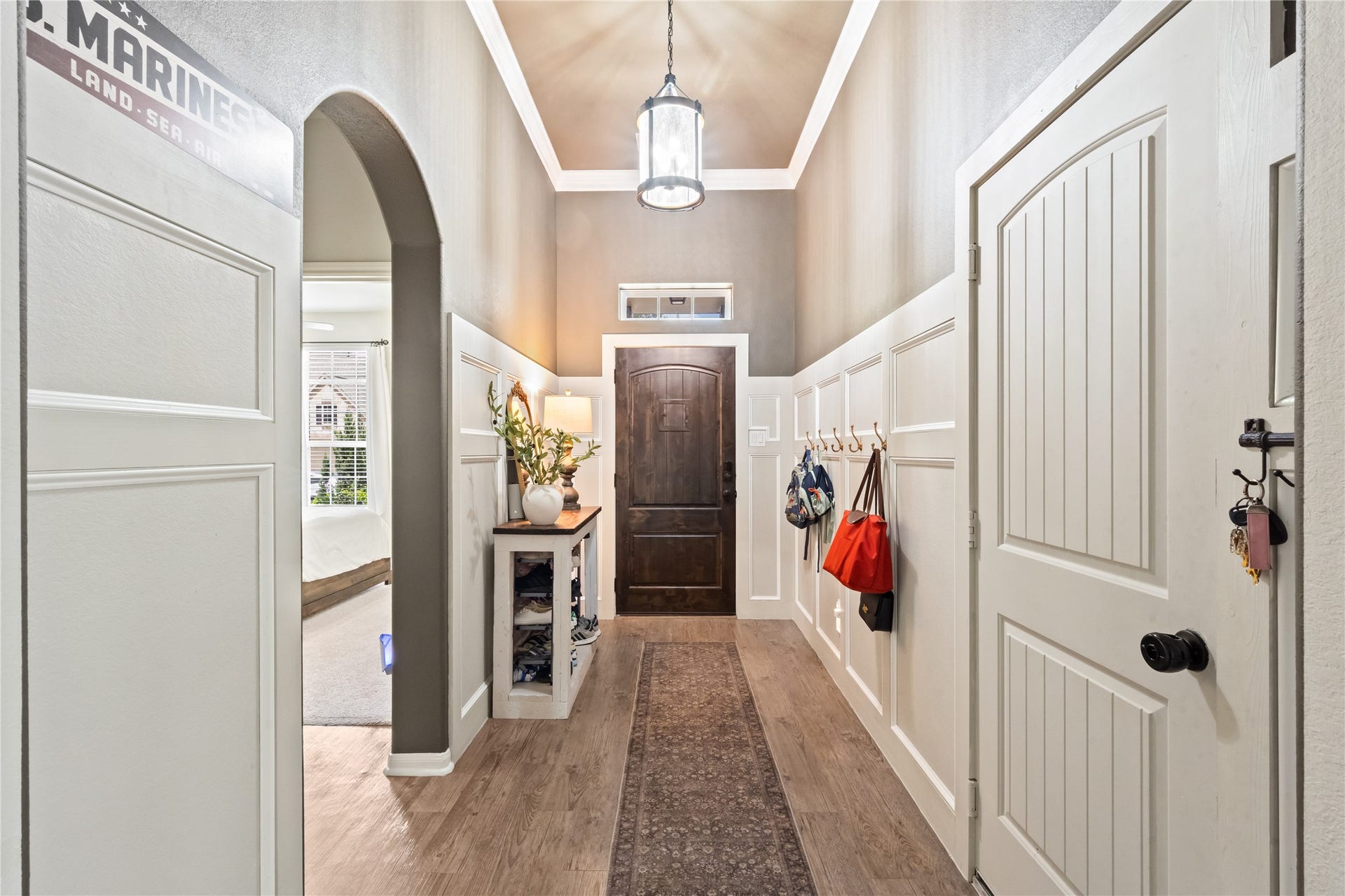 This breathtaking entryway features upgraded accent walls complete with convenient hooks for hanging your belongings.