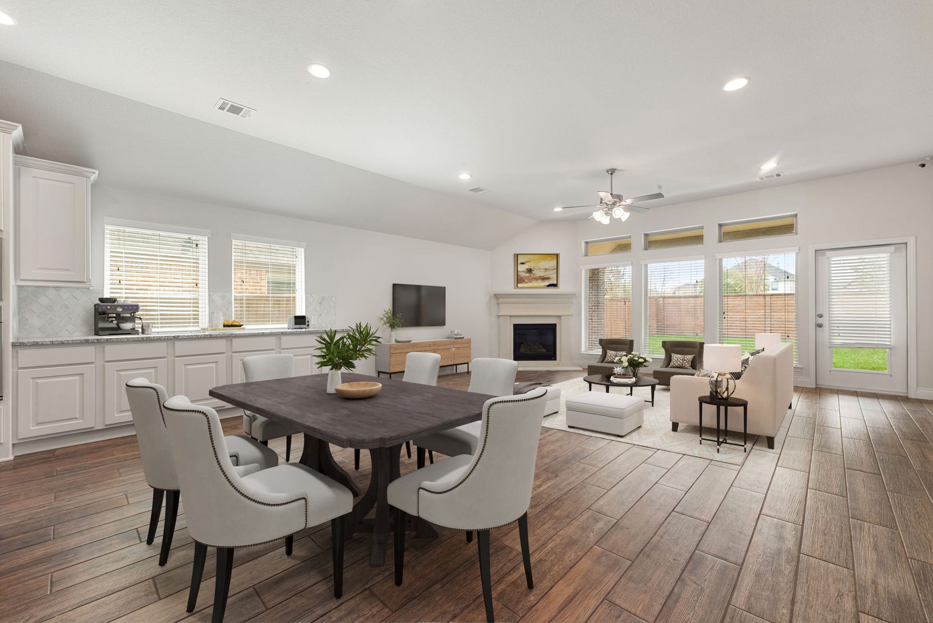 2419 Elmwood Trail, Katy, TX 77493 Spacious open-concept dining and living area with wood-look flooring, recessed lighting, and large windows that bring in plenty of natural light. Perfect layout for entertaining and comfortable everyday living.
